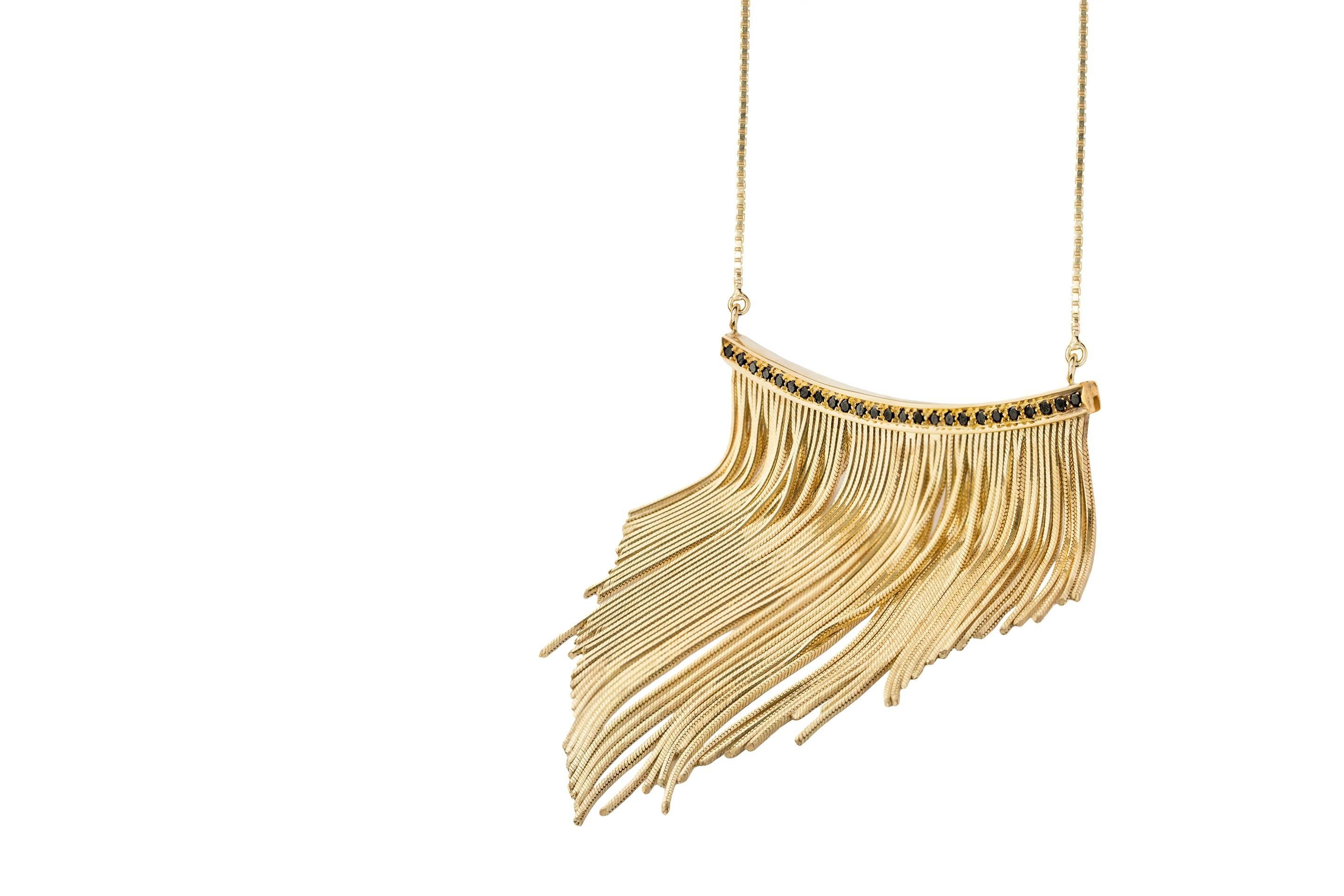 The traditional elegance of gold is given a modern feminine interpretation in this statement fringed necklace from Iosselliani. Wisely crafted with a 18 Karat yellow solid gold custom made chain, the necklace features a central with 0,58 carats