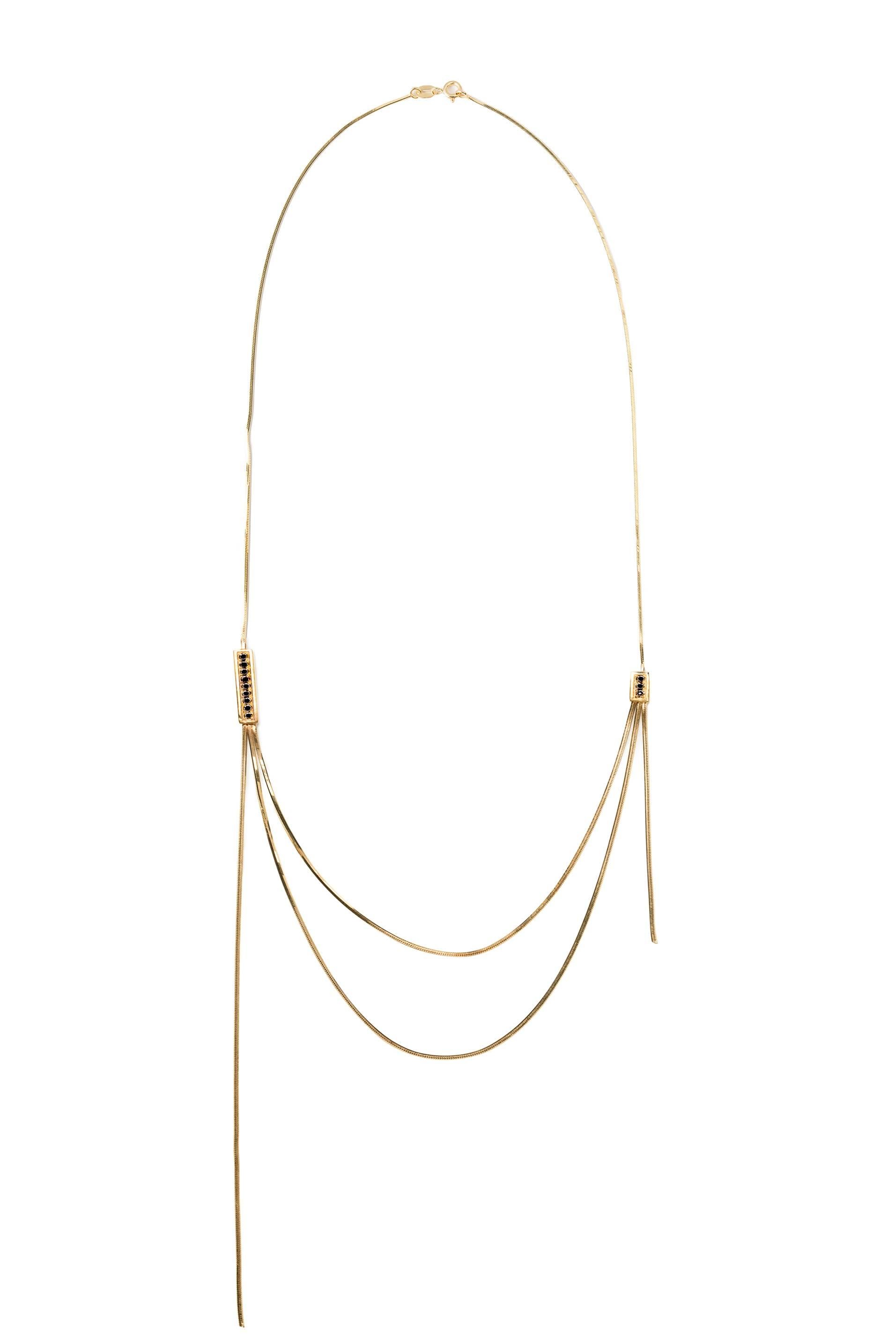 The traditional elegance of gold is given a mid-century modern interpretation in this minimal necklace from Iosselliani. Inspired by the ability of the brand to translate traditional details into modern directions, this three tiered necklace relies