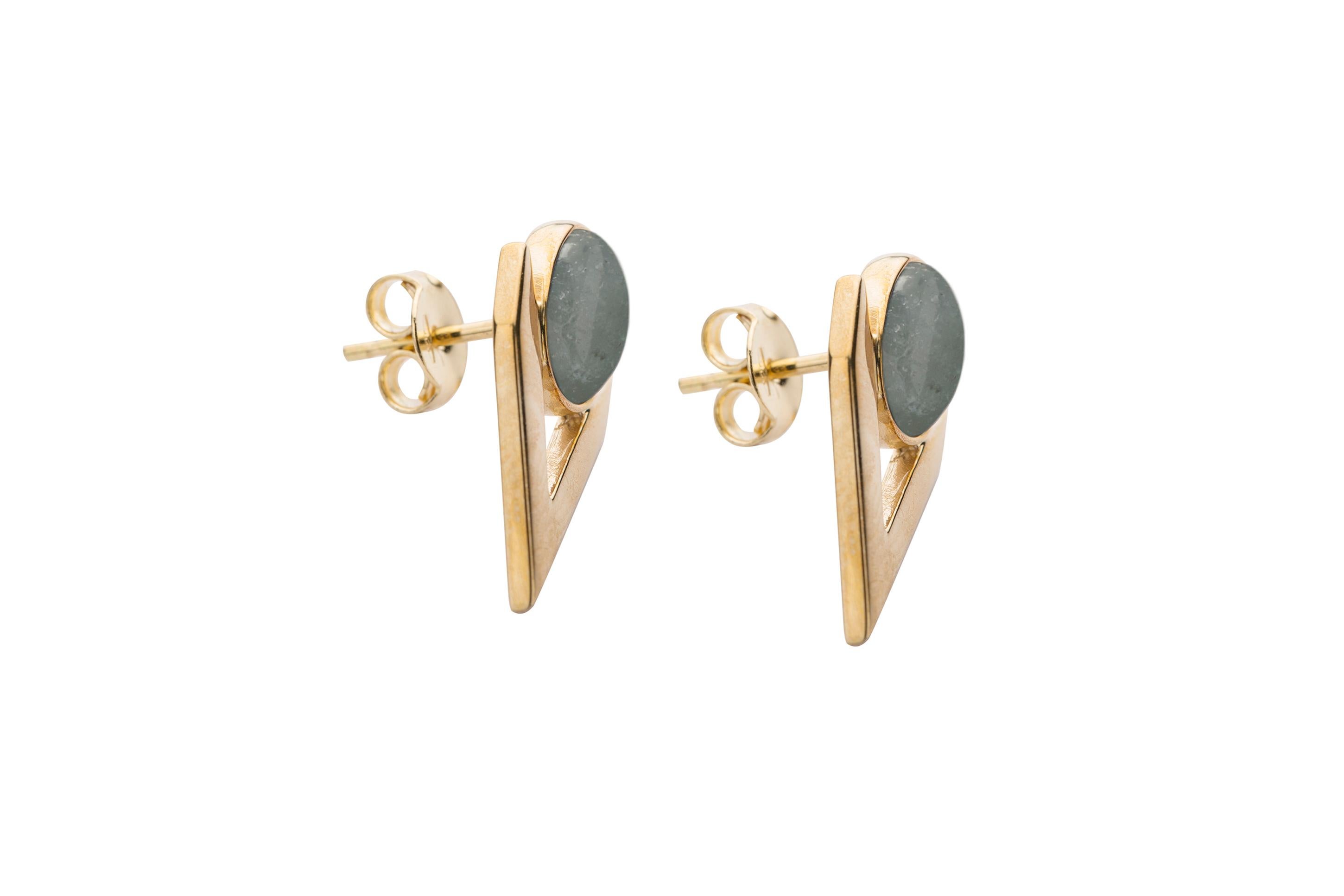 Iosselliani goes with a contemporary minimalistic interpretation in this V shaped earrings. Founded upon 9k yellow gold, this piece features an oval cabochon in aquamarine framed into a V shape. Butterfly post for pierced lobes. Stone size 8x6mm.