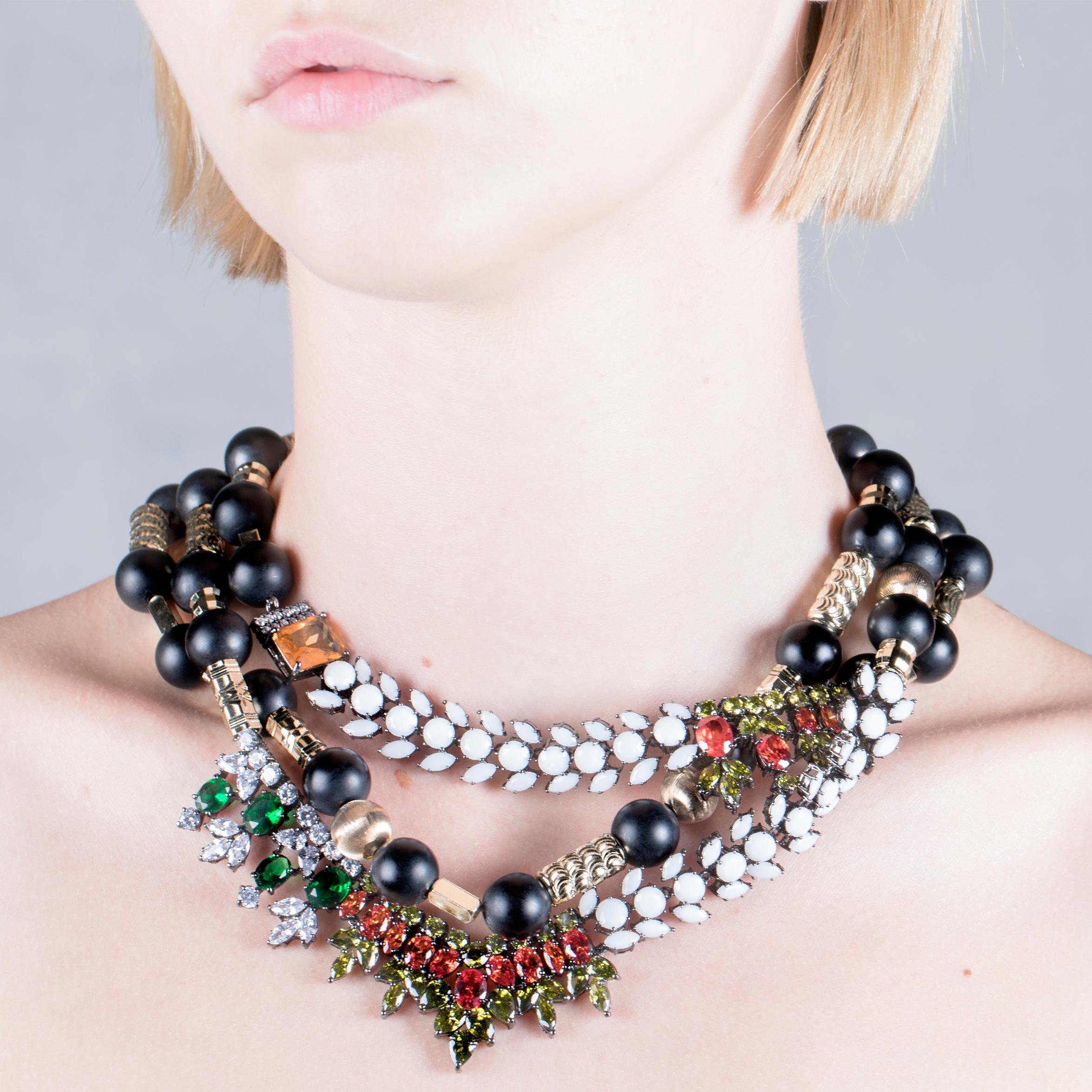 Inject a dose of color with this IOSSELLIANI CLUB AFRICANA statement necklace. Following the vocation of the brand, this piece translates colors and shapes into eclectic jewels, featuring a cascade of white glass stones mixed with a green and orange