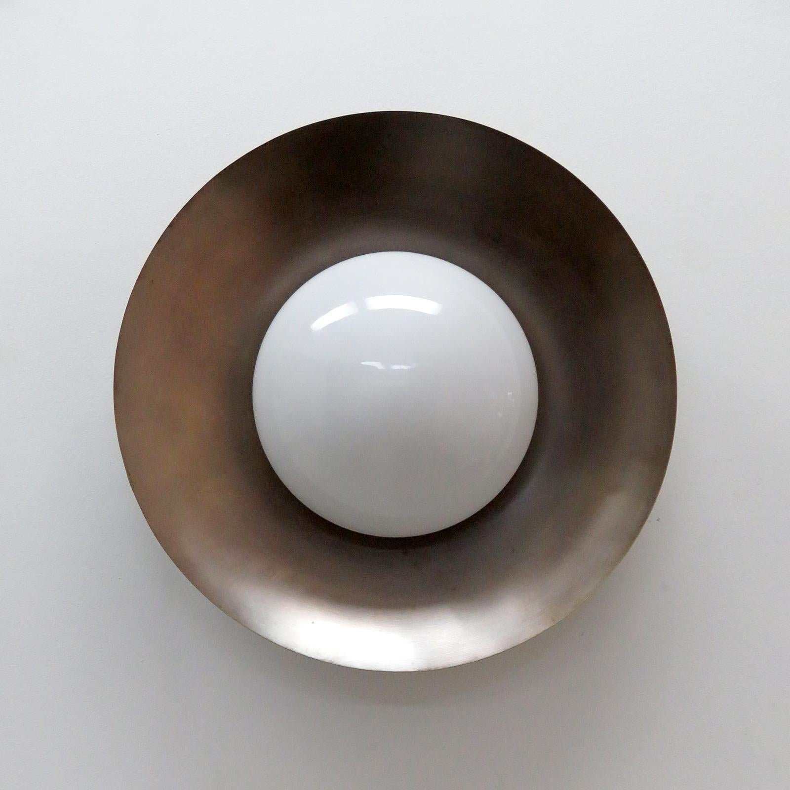 Elegant Iowa flush mount light designed by Gallery L7, handcrafted and finished in Los Angeles from American brass, with an opaline glass shade on an aged raw brass perforated disc. One E26 socket per fixture, max. wattage 60w or 3-7w LED