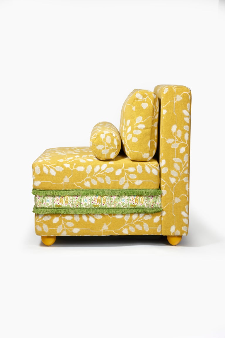 Upholstered chauffeuse with yellow glossy lacquered ball feet.
 