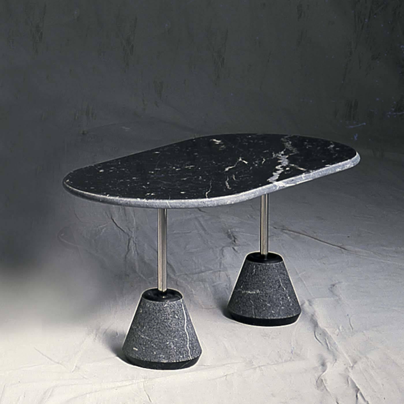 The structure of this exclusive coffee table designed by Achille Castiglioni for UpGroup is both light and robust, as it plays on the idea of balance and tension, giving the design a dynamic quality. The striking black Marquinia oval top rests on a