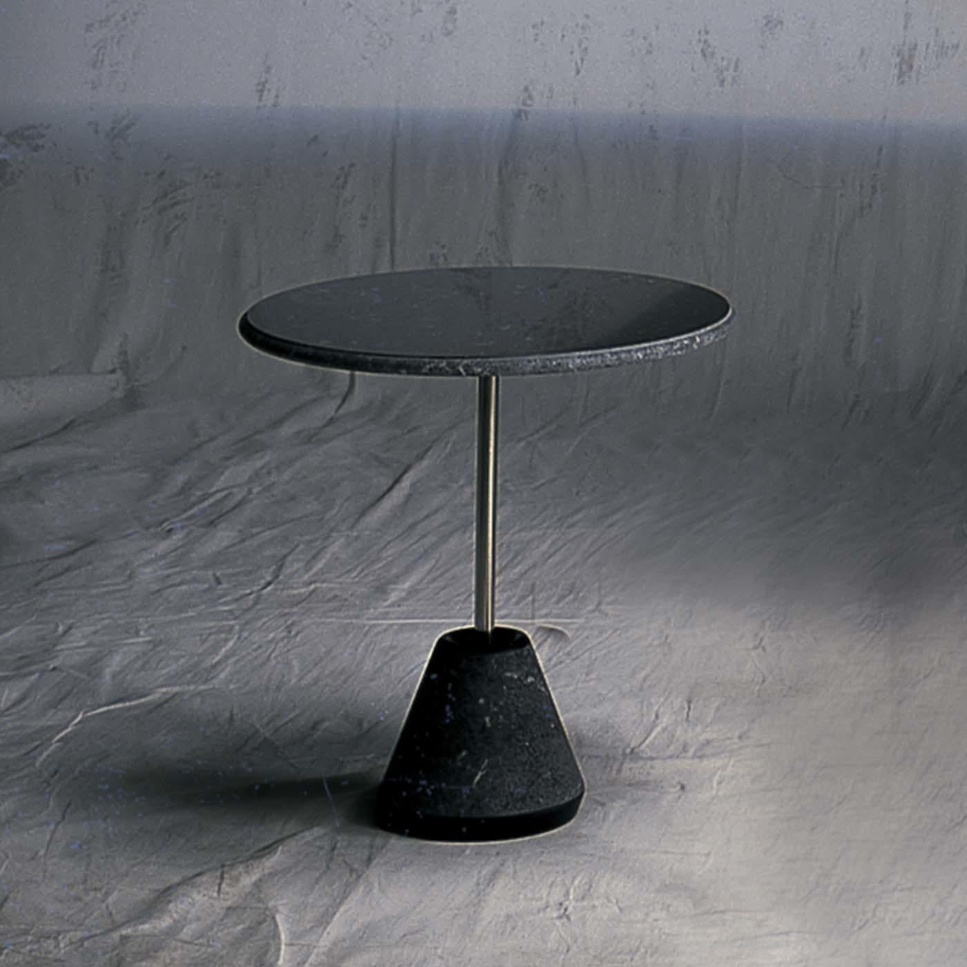 The Ipaz collection by Achille Castiglioni for UpGroup features tables that are a decorative furniture complements, easy and versatile, designed with an elegant and refined shape. The cylindrical base is made of black Marquina marble with a