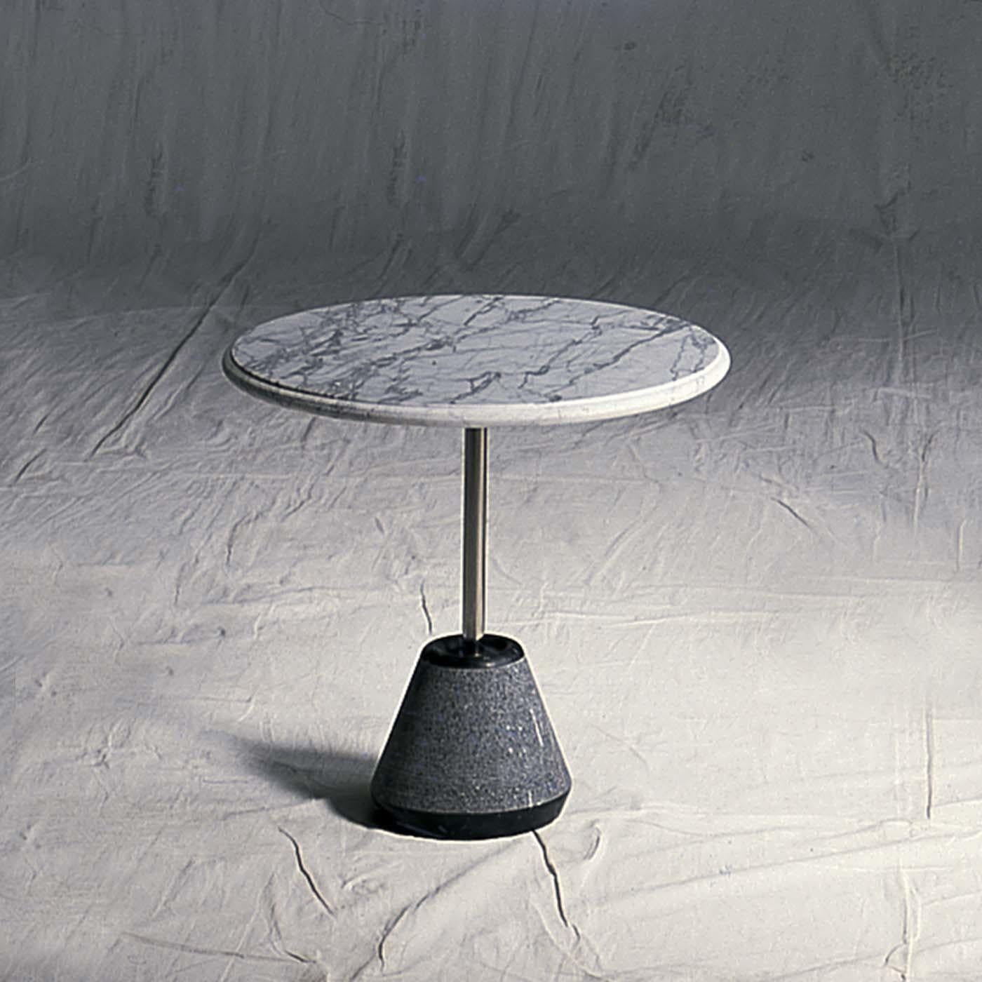 Designed by Achille Castiglioni exclusively for UpGroup in 1992, this minimalist table combines the elegance of the marble with a bold industrial design. Its defining characteristic is the splendid white Carrara marble top that stands out for its