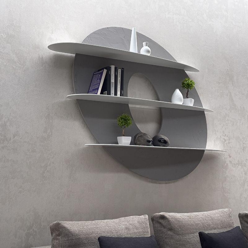 Wall bookcase with an innovative design, with rounded and soft shapes, conceived as an idea to decorate. The original design makes it versatile. It is made with an elliptical back panel, emptied and worked to create a floating effect, and three