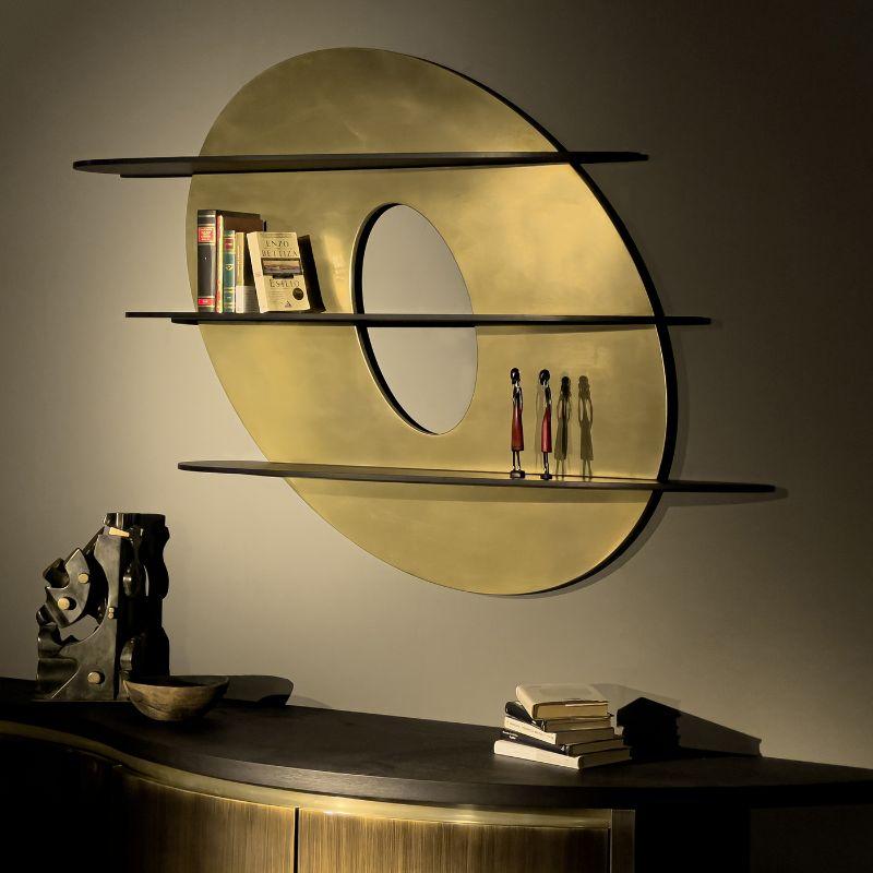 The unusual design of the bookcase Iperbole makes it versatile. Not only display your books but also decorate your home in an elegant and luxurious way. It is made with an elliptical-shaped back panel, emptied and worked to create a floating effect,
