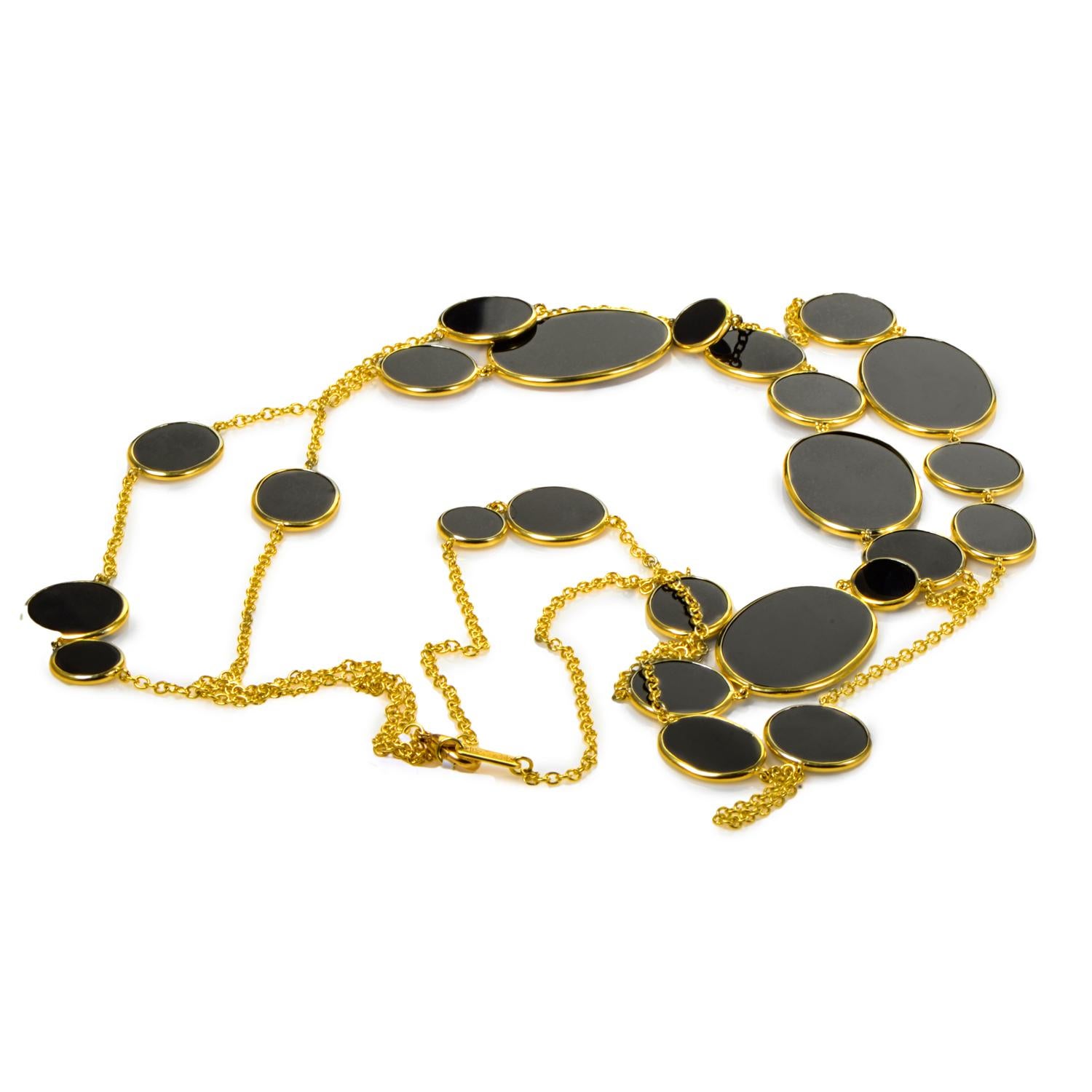 This Ippolita necklace is unique and ravishing. The necklace is made of 18K yellow gold and has smooth black onyx going across to make this a striking piece.