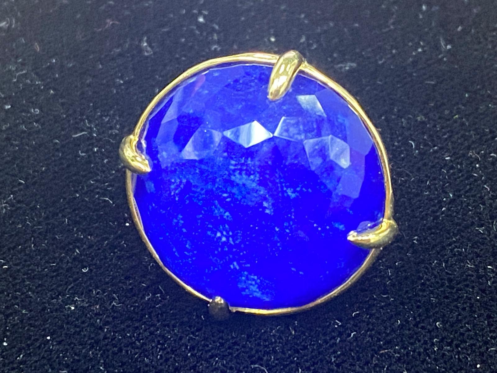 Gorgeous Rock Candy Prince Ring by Ippolita.
Features a lapis slab behind a faceted rock crystal in a prong setting.

Setting Diameter: 26 mm.
Size: 6.75.
Metal: 18k yellow gold.
Weight: 15.4 grams.

Reference Item # DB-1113 (JP3/6/25).