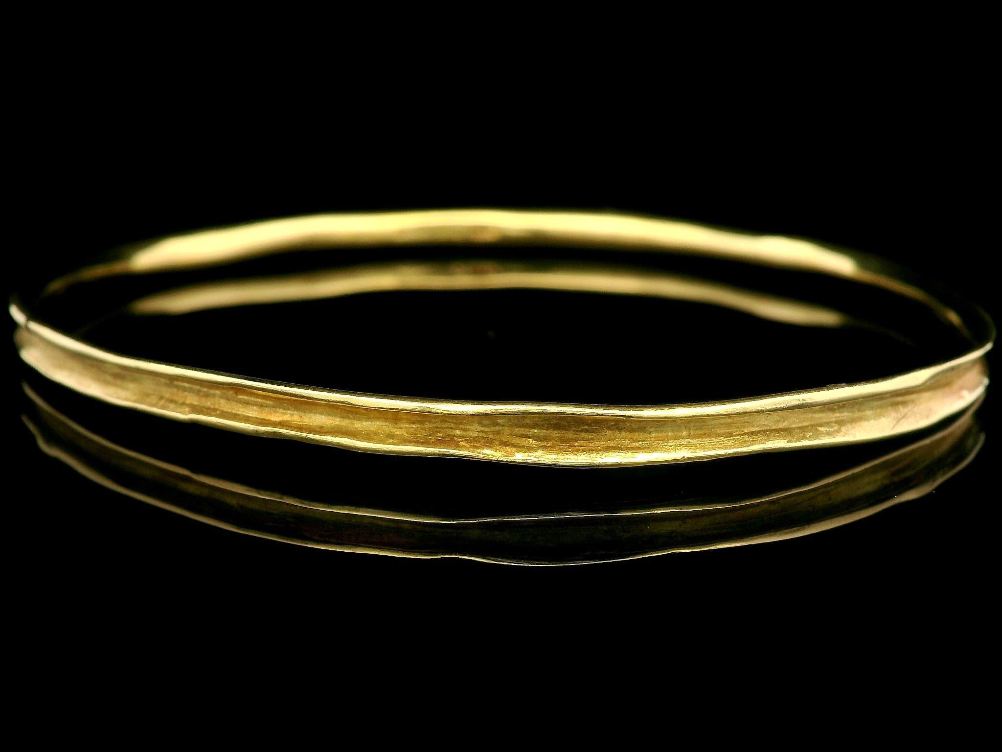 Material: Solid 18k Yellow Gold
Weight: 12.55 Grams
Type: Slip On bangle 
Overall Length: Will comfortably fit up to 7.75” (measured on wrist)
Overall Width: 65.7mm (2.5