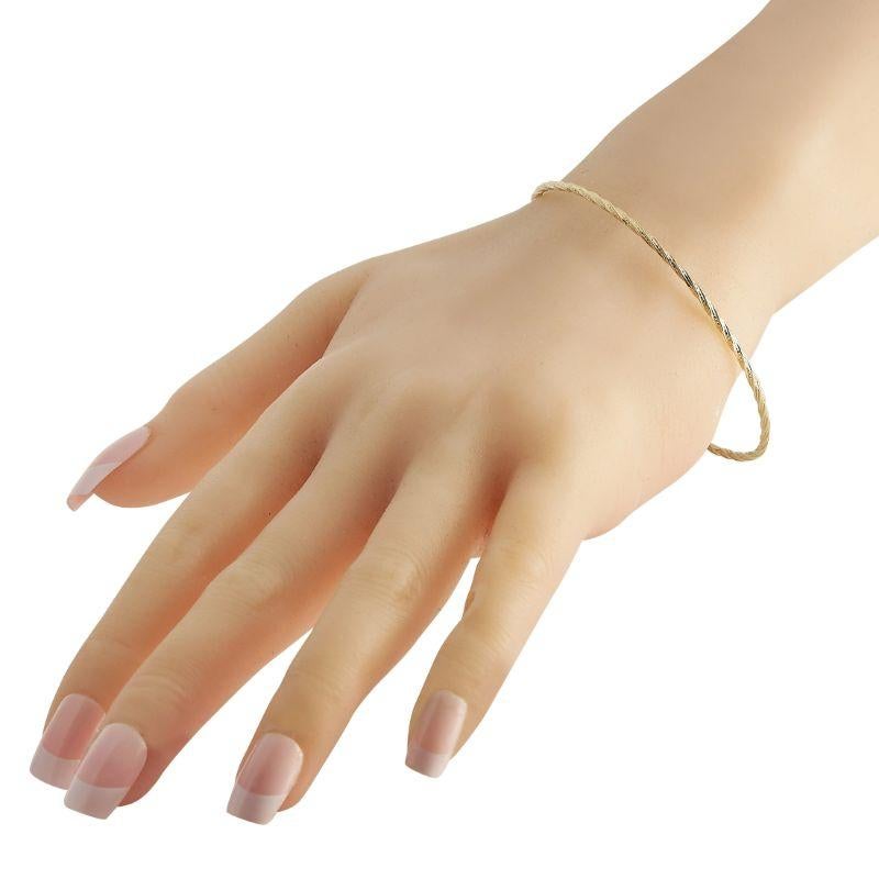 A simple and lightweight yellow gold bangle with a personality. This Ippolita creation features a twisted rope-like silhouette. The thin profile makes it suitable for stacking. The bangle measures 7.5 inches and weighs 6.5 grams.
 
 This Ippolita