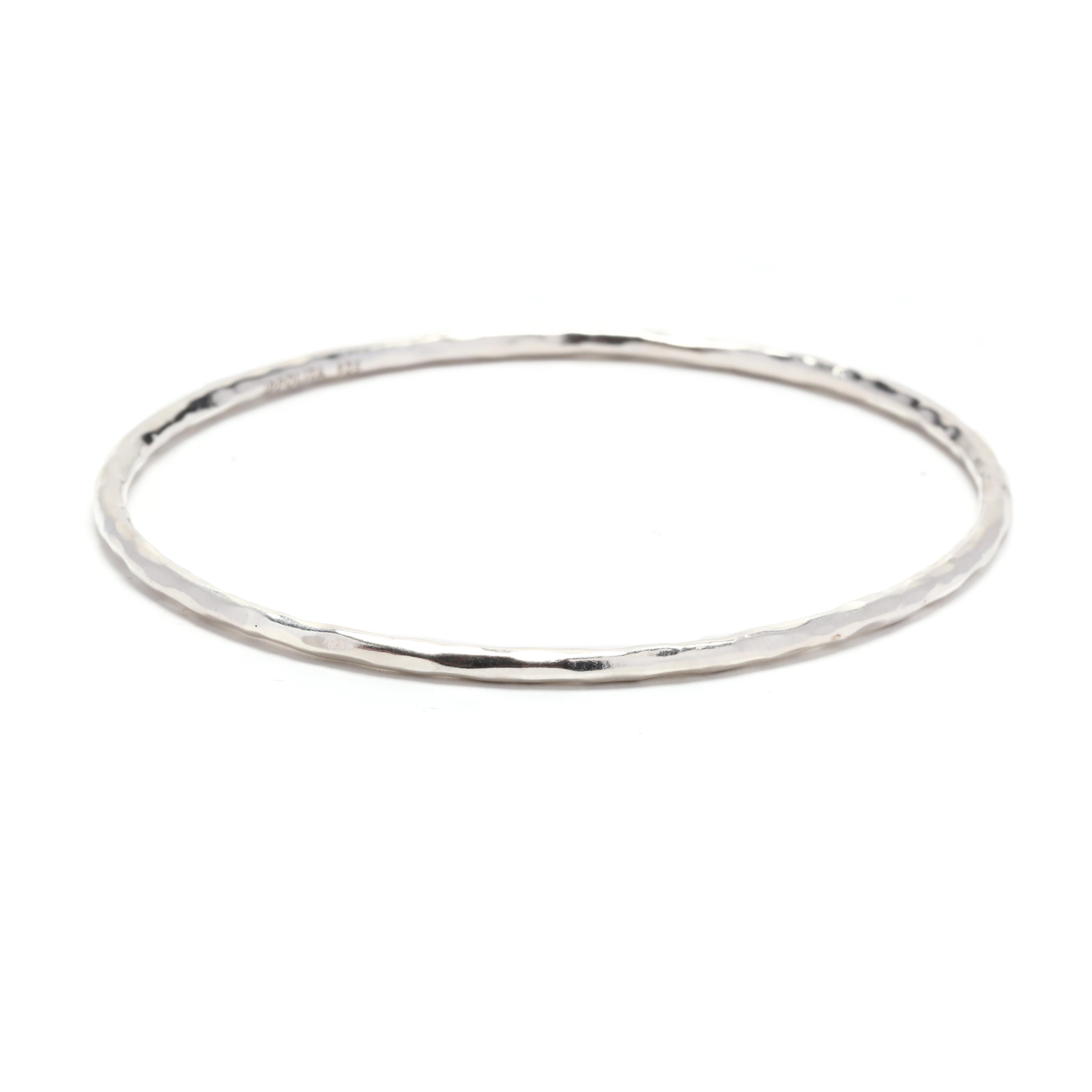 Adorn your wrist with this stunning Ippolita bangle bracelet. Made from high-quality sterling silver, this bracelet showcases a sleek and modern design that is perfect for everyday wear. The bracelet measures 7.75 inches in length, making it a