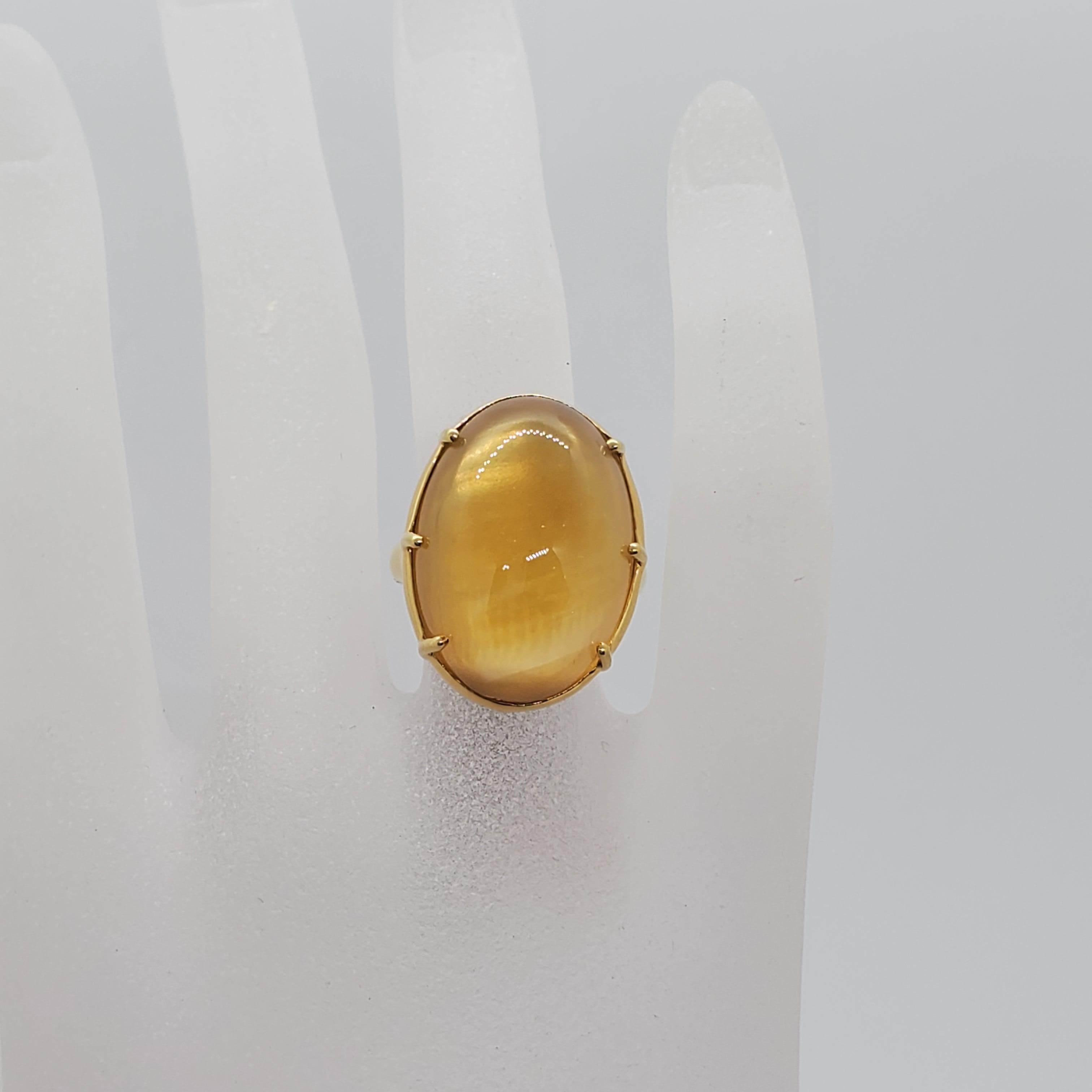 Unique Ippolita estate ring featuring an oval cabochon mother of pearl in a handmade 18k yellow gold mounting. Simple yet powerful, this ring is versatile and easy to wear for any event.
