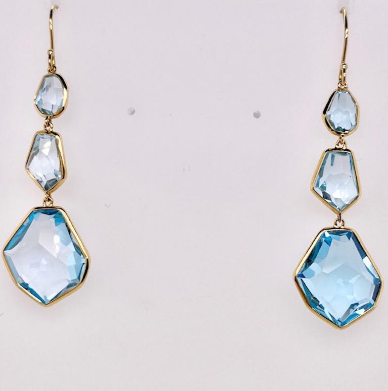 Sparkling faceted blue topaz triple drop earrings.  Made and signed by IPPOLITA.   The stones are hand-cut and purposefully irregular to follow the brilliance and shape of each stone.  18K yellow gold.  2