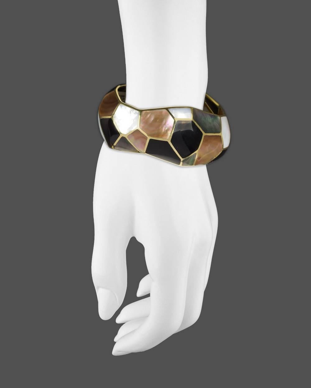 Wide bangle bracelet, showcasing a mosaic of various-sized inlaid white and gray mother-of-pearl, as well as black onyx, in polished 18k yellow gold, signed Ippolita. 1.18 wide bangle. Interior dimensions: 2.63 x 2.28