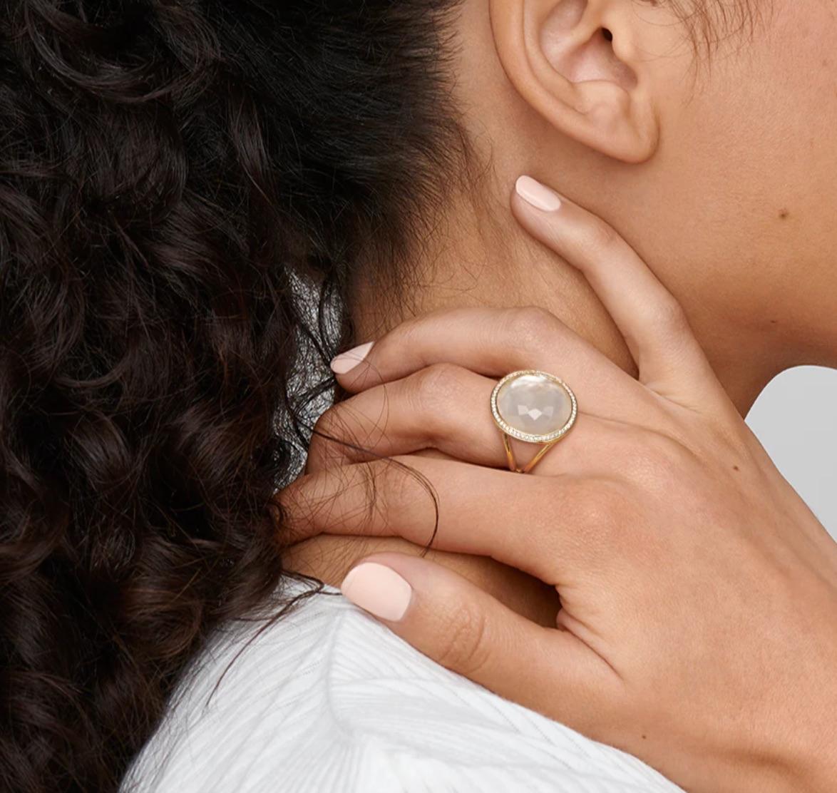 This fun ring design by Ippolita is in their Lollipop collection, featuring a bright mother-of-pearl backing with faceted rock crystal overlay, surrounded by round brilliant cut diamonds weighing 0.26 carats. Mounted in 18 karat yellow gold, this