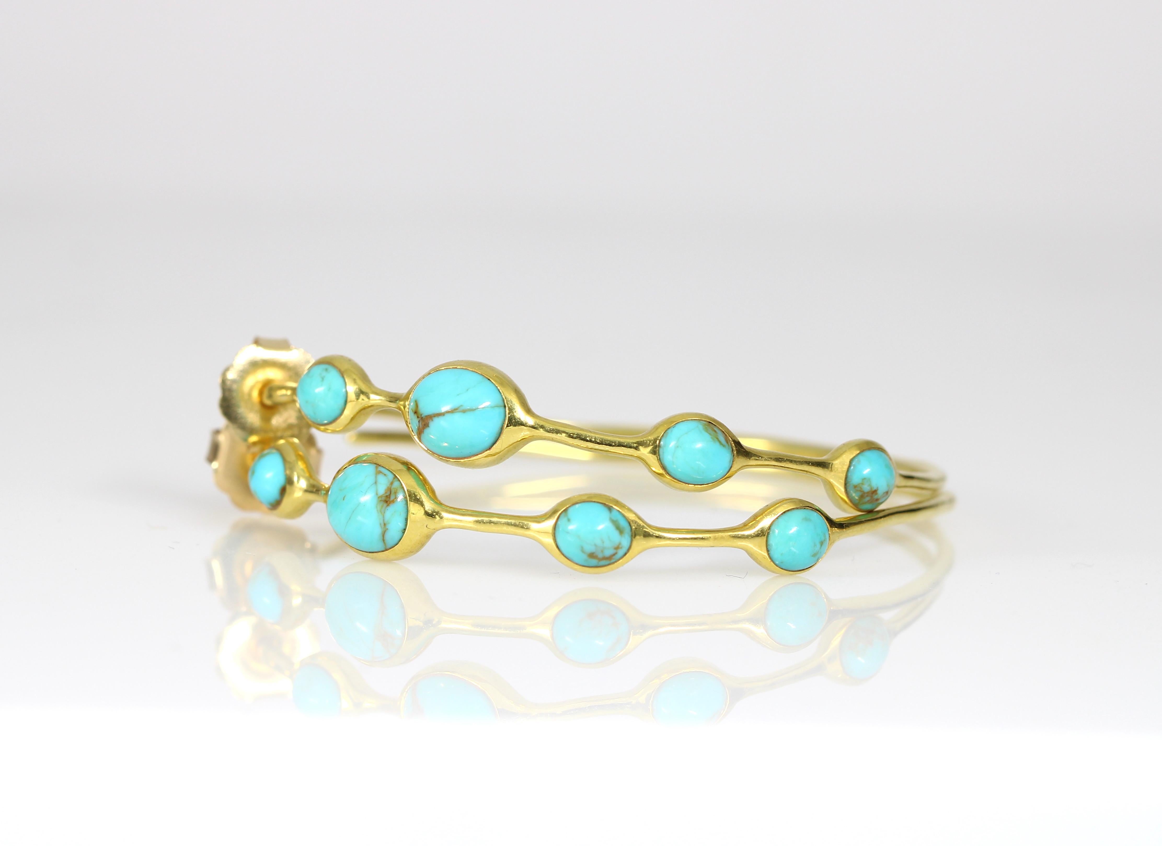 Up for sale is a pair of stunning turquoise Ippolita 18k yellow gold hoops with a hammered finishing. The earrings feature four stones on each earring, for a total weight of approximately 12 carats. The earrings are versatile making them perfect for