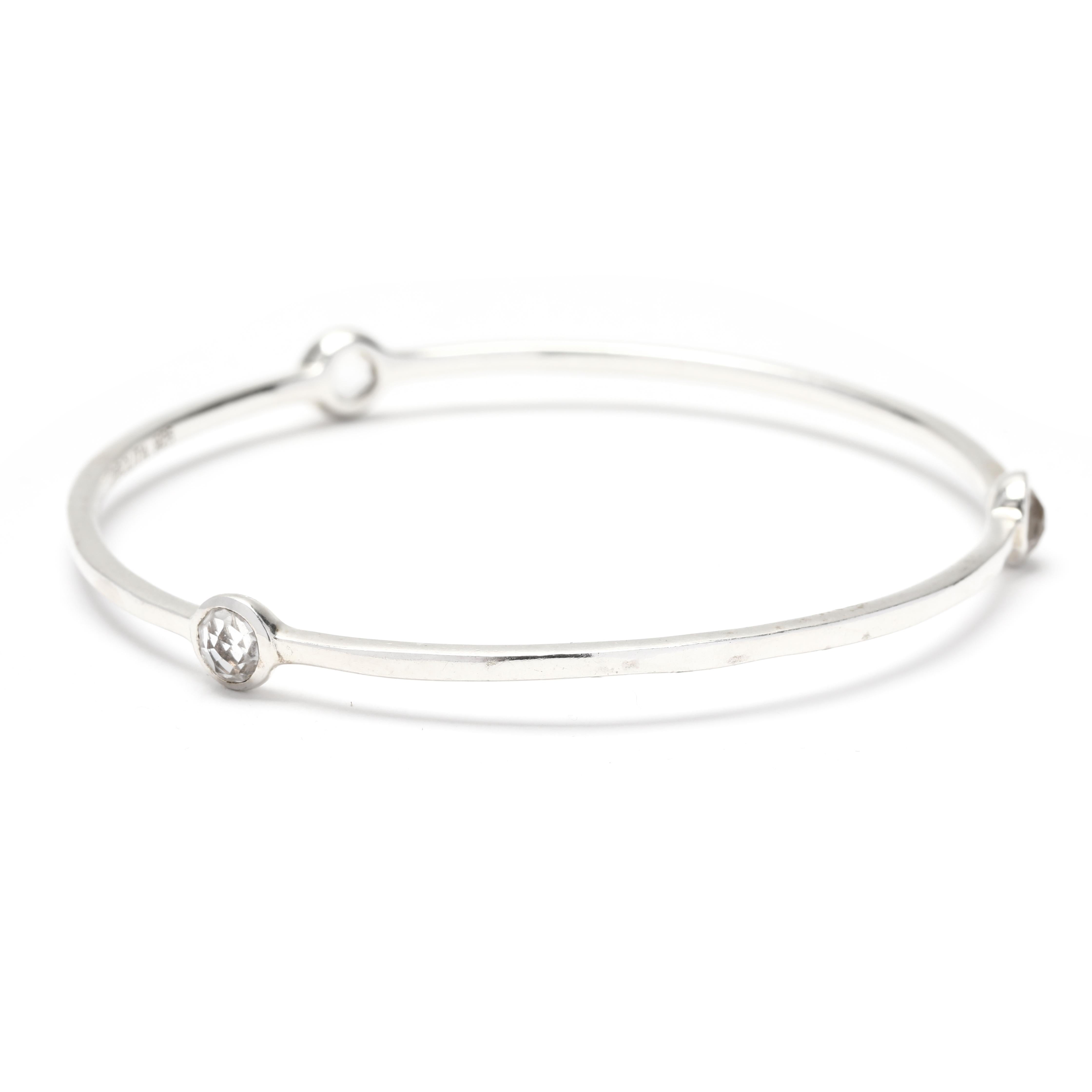 This elegant Ippolita Rock Candy 3 Stone Clear Quartz Bangle Bracelet is a stunning addition to any jewelry collection. Made from sterling silver, this simple bangle bracelet features three clear quartz stones set in a row.

Stones:
- clear quartz,