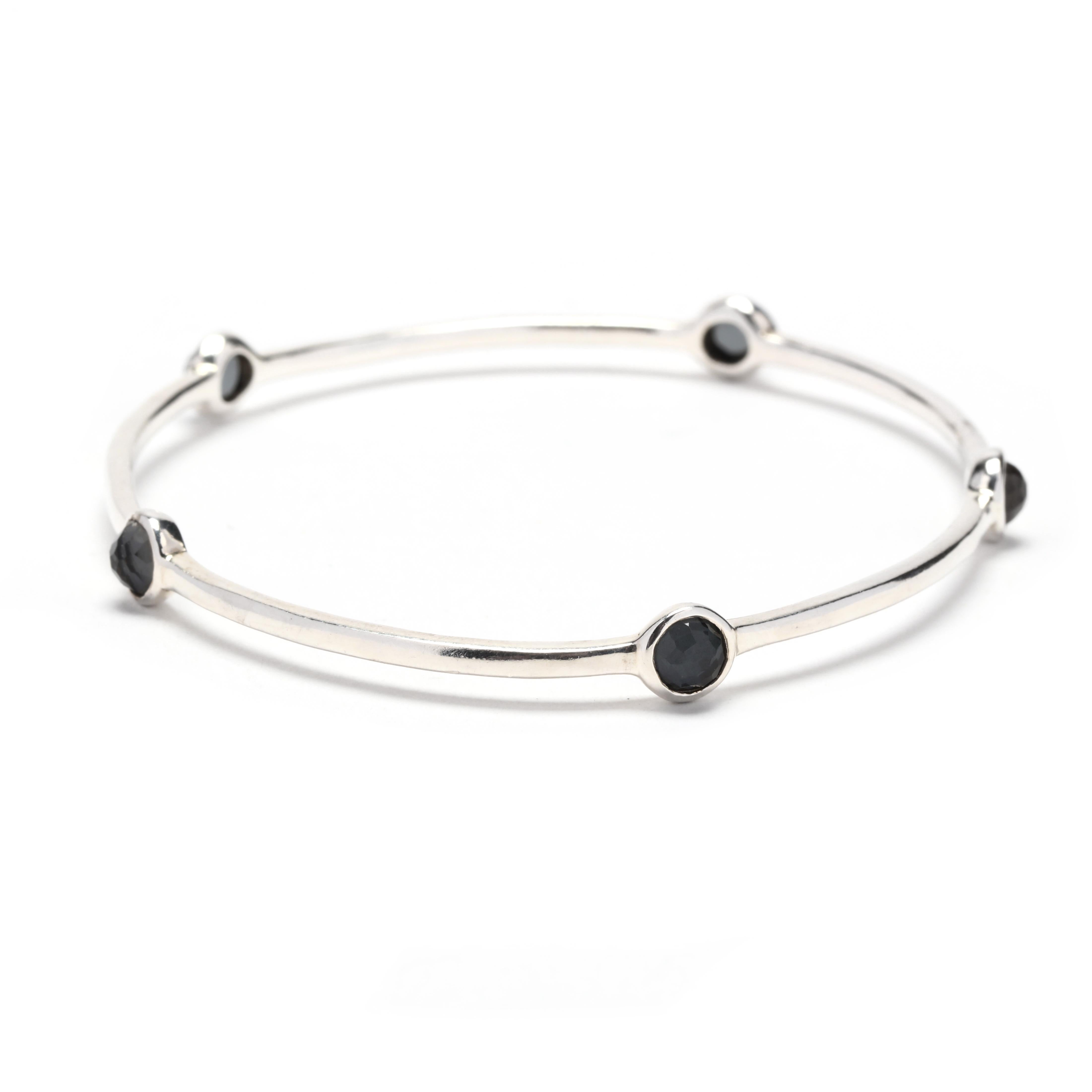 This beautiful and unique Ippolita Rock Candy Hematite 5 Stone Bangle Bracelet is handcrafted with sterling silver and features five stunning hematite stones. The dark, metallic gray stones add a sophisticated and elegant touch to any outfit.