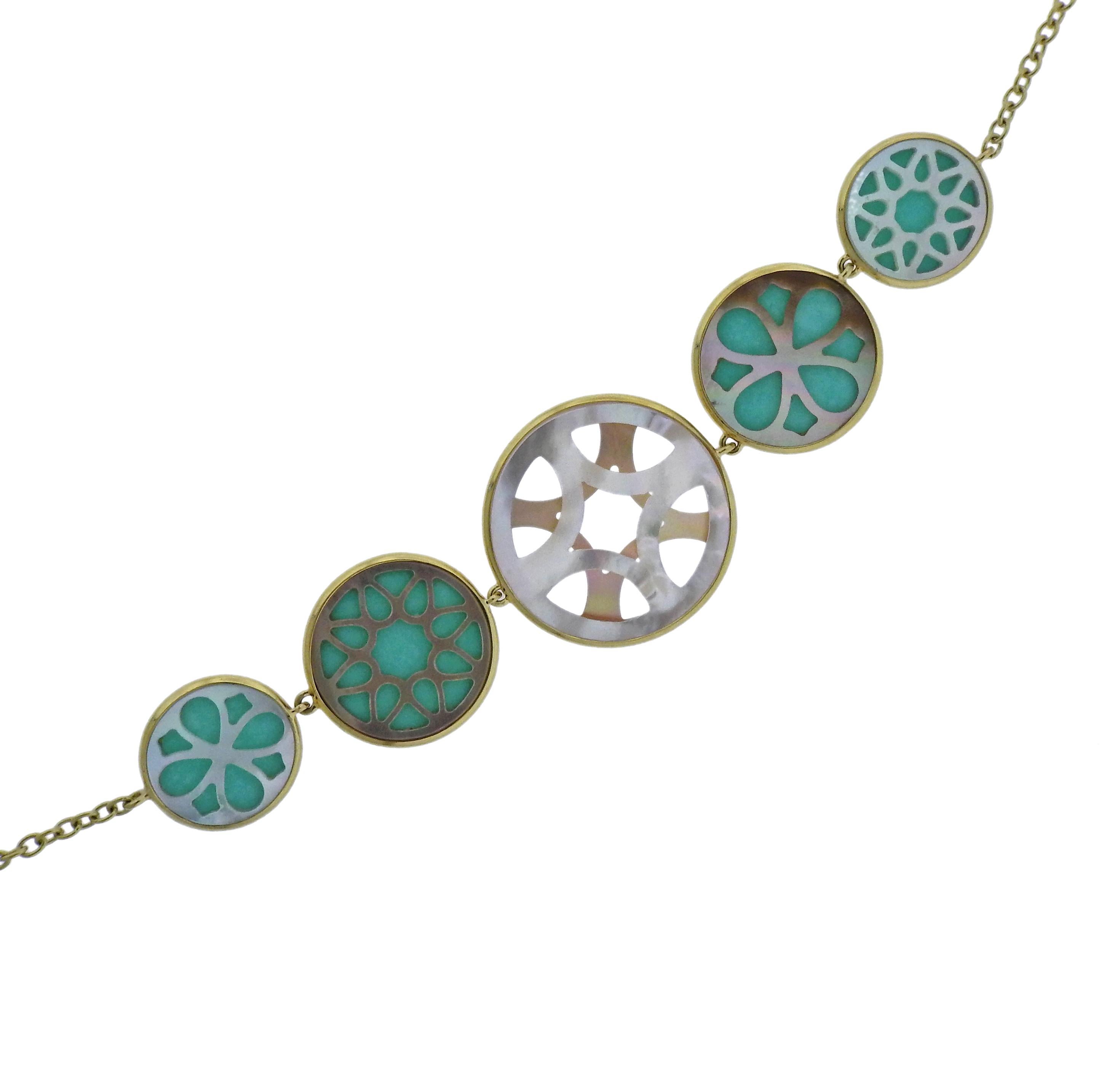 18k gold long station necklace, featuring turquoise and cut out mother of pearl.  Necklace is 38