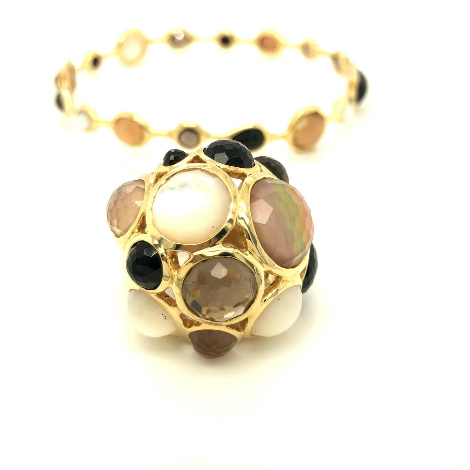 Such a fun and bold statement piece, Rock Candy dome ring features multi gemstones - mother of pearl, smokey quartz, and onyx. The ring is crafted in 18K yellow gold, marked Ippolita 18K. Matching bangle bracelet is available. 

Measurement: 1.25