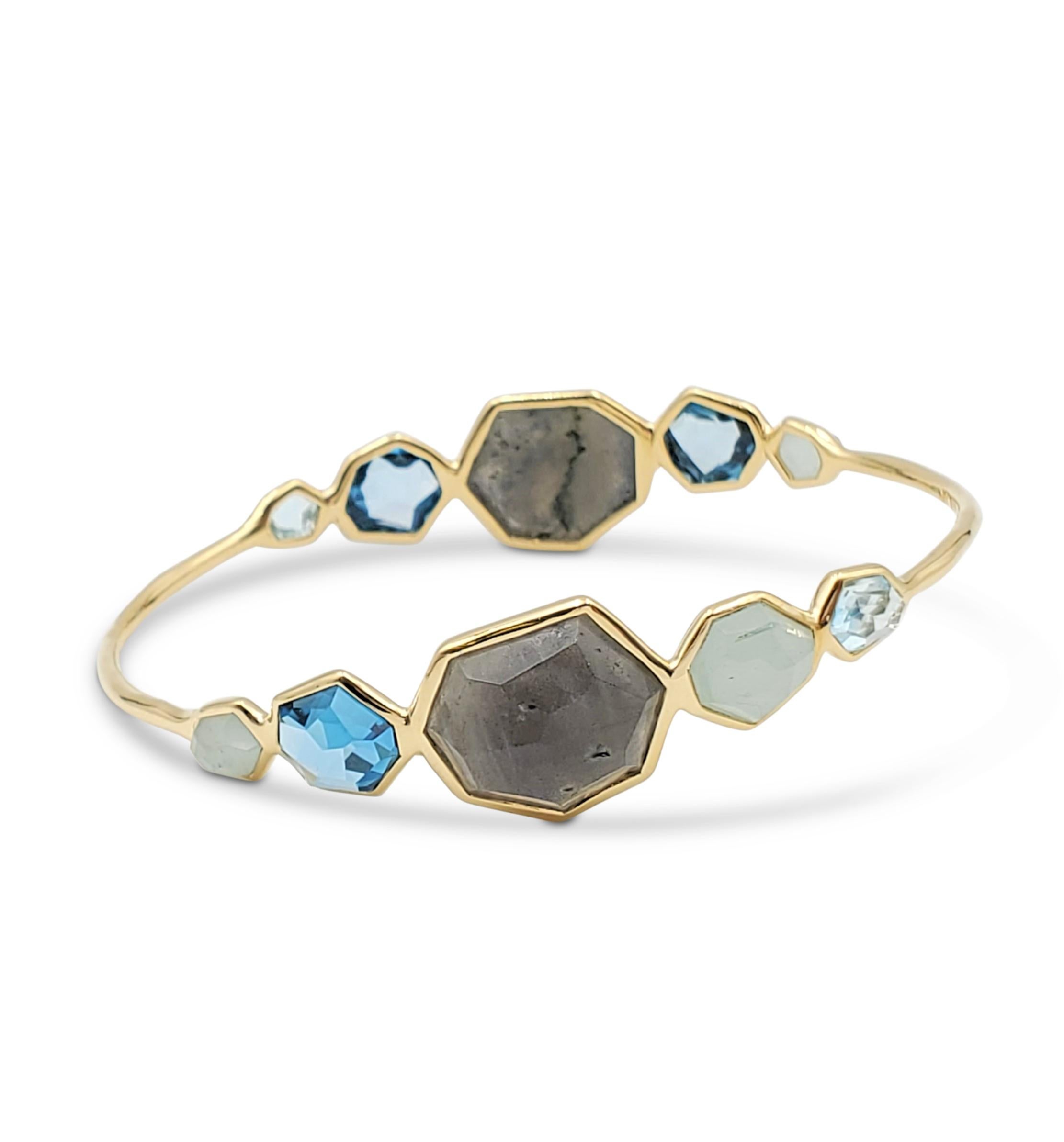 Authentic Ippolita 'Rock Candy' bangle crafted in 18 karat yellow gold displaying a mixture of blue gemstones in a variety of shapes. Signed Ippolita, 18K. The bangle is not presented with the original box or papers. CIRCA 2010s.

Bracelet Inside