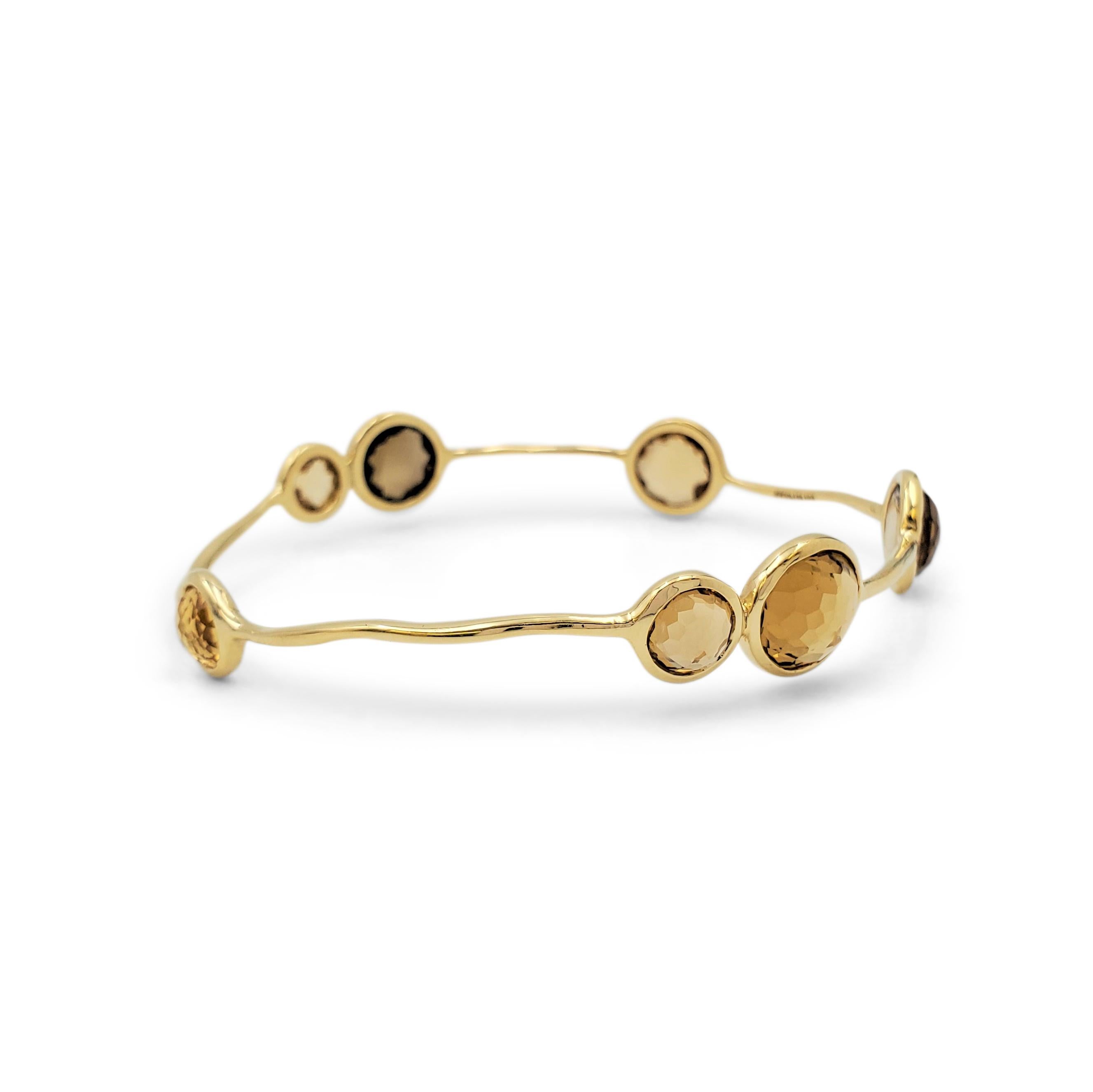 Authentic Ippolita 'Rock Candy' bangle crafted in freeform 18 karat yellow gold set with 7 bezel-set, multi-sized 'cognac' citrine stones with a rose cut. The bangle is stamped 18K and signed Ippolida. The bangle is not presented with the original