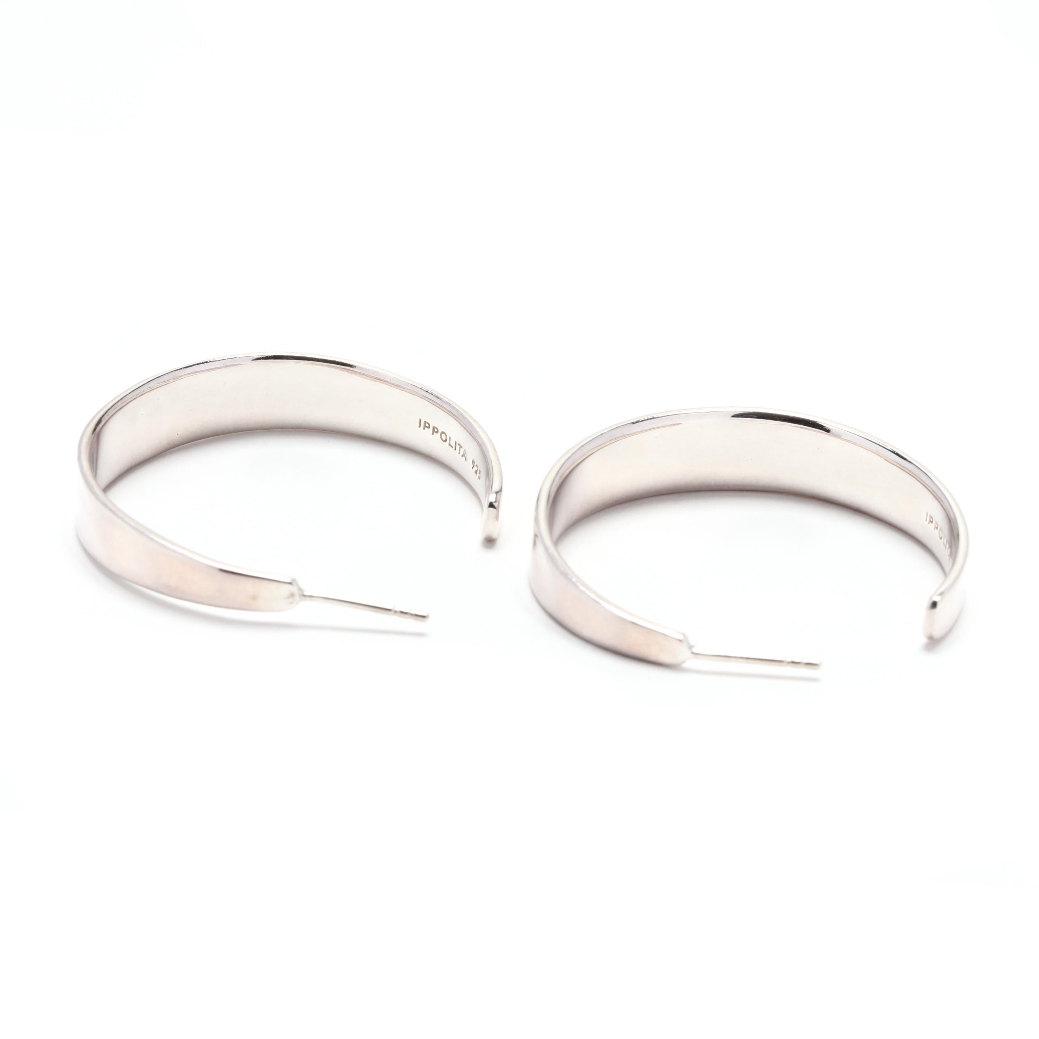 A pair of Ippolita sterling silver tapered hoop earrings. These earrings feature a faceted, concave tapered design with pierced butterfly earring backs.



Length: 1 3/8 in.



Width: 7.75 mm



Weight: 13.7 grams