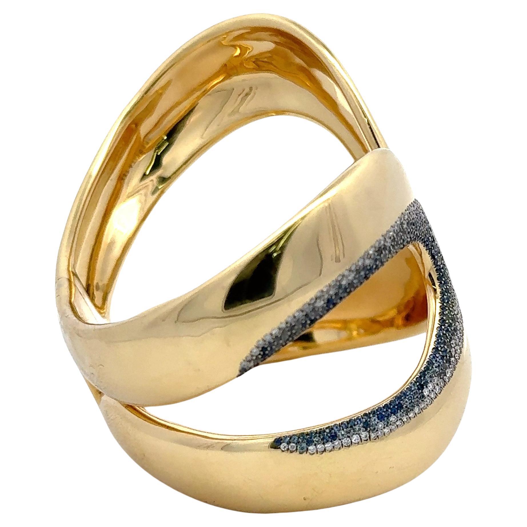 Signed Ippolita, this 18 karat yellow gold wide bangle features a stardust of round brilliants and Sapphires weighing 1.51 grams. 
Approximately 5 Carats of Diamonds
Made in Italy
Hinged Closure
Original Price: $32,000