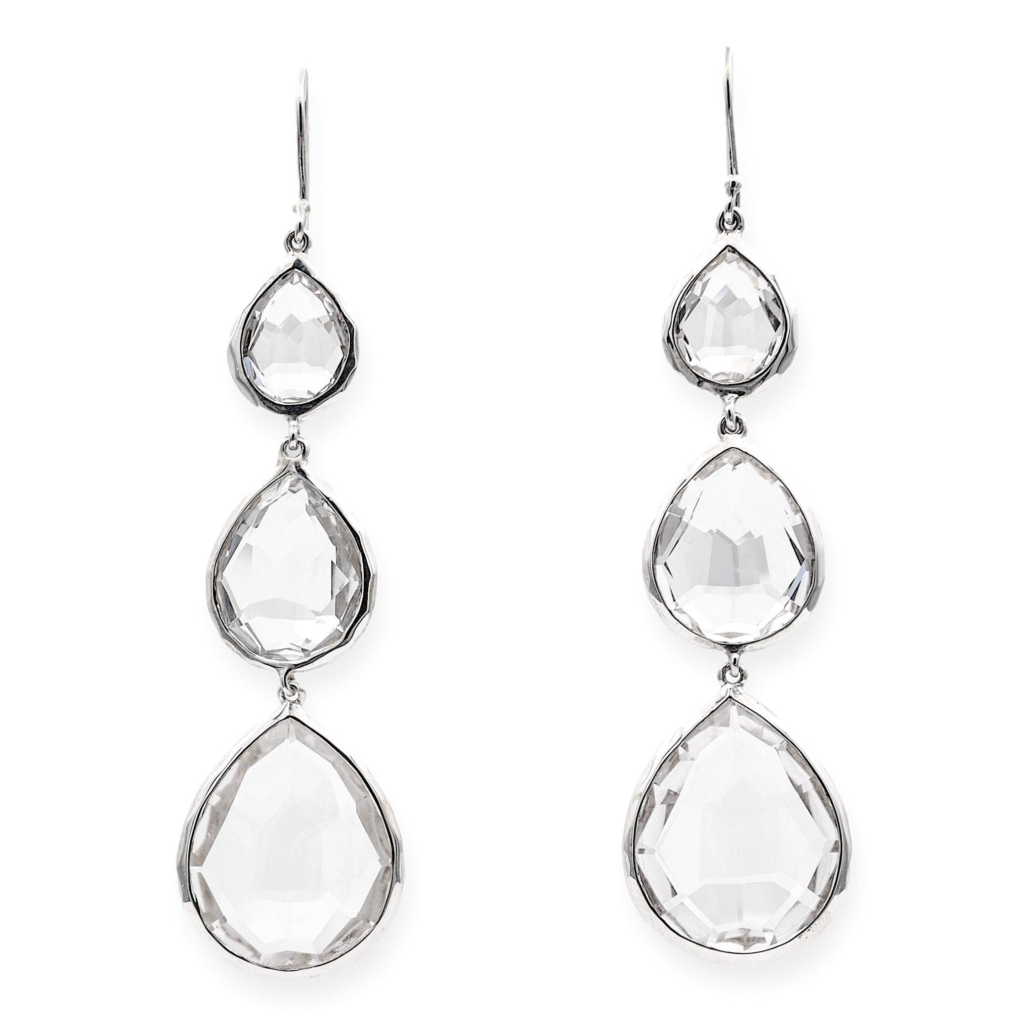 Pair of tear drop earrings by IPPOLITA finely crafted in sterling silver featuring three pear shape rock crystal stones set inside a bezel frame. Earrings drop about 3 inches long with french wire. Fully hallmarked with logo and metal
