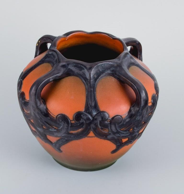 Ipsens, Denmark. Art Nouveau vase in hand-painted glazed ceramics. 
Design Karen Hagen 1909. 
Model number 710.
Measures: D 21,0 x H 16.5 cm.
In very good condition. Insignificant chip in the bottom.
Marked.