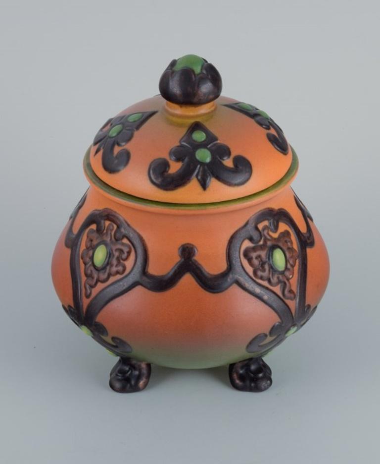 Ipsens, Denmark, beautiful Art Nouveau jar with glaze in orange and green tones.
1920s-1930s.
Model number 739.
Marked.
In excellent condition.
Dimensions: D 15.0 x H 18.5 cm.