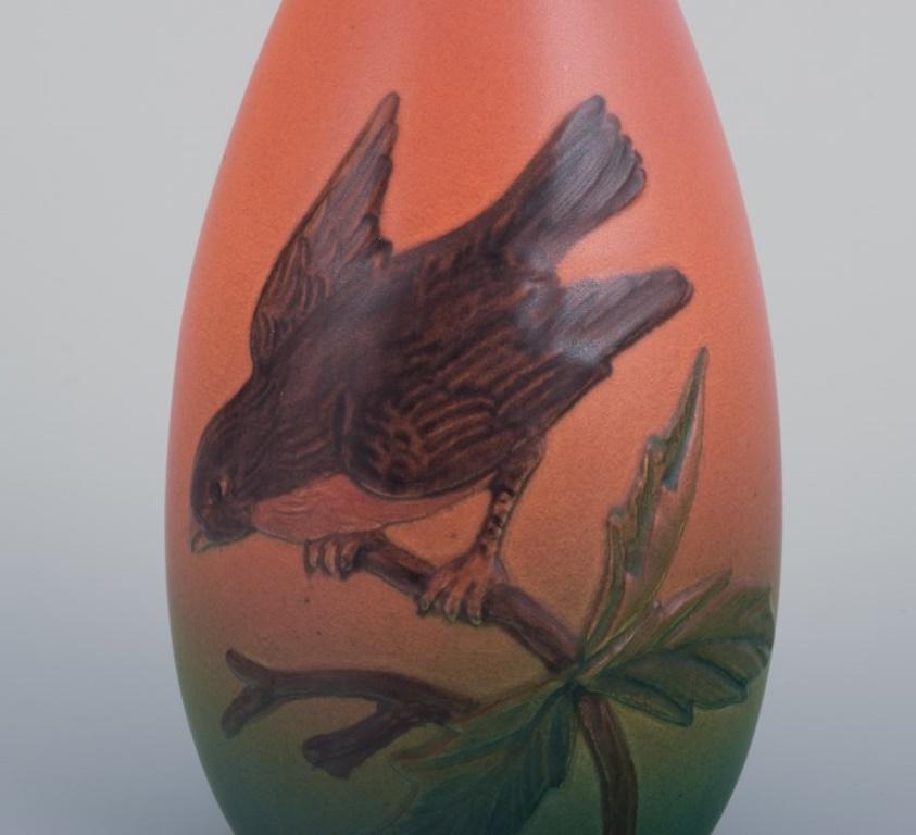 Danish Ipsens, Denmark, ceramic vase with a bird motif on a branch. Approx. 1930 For Sale