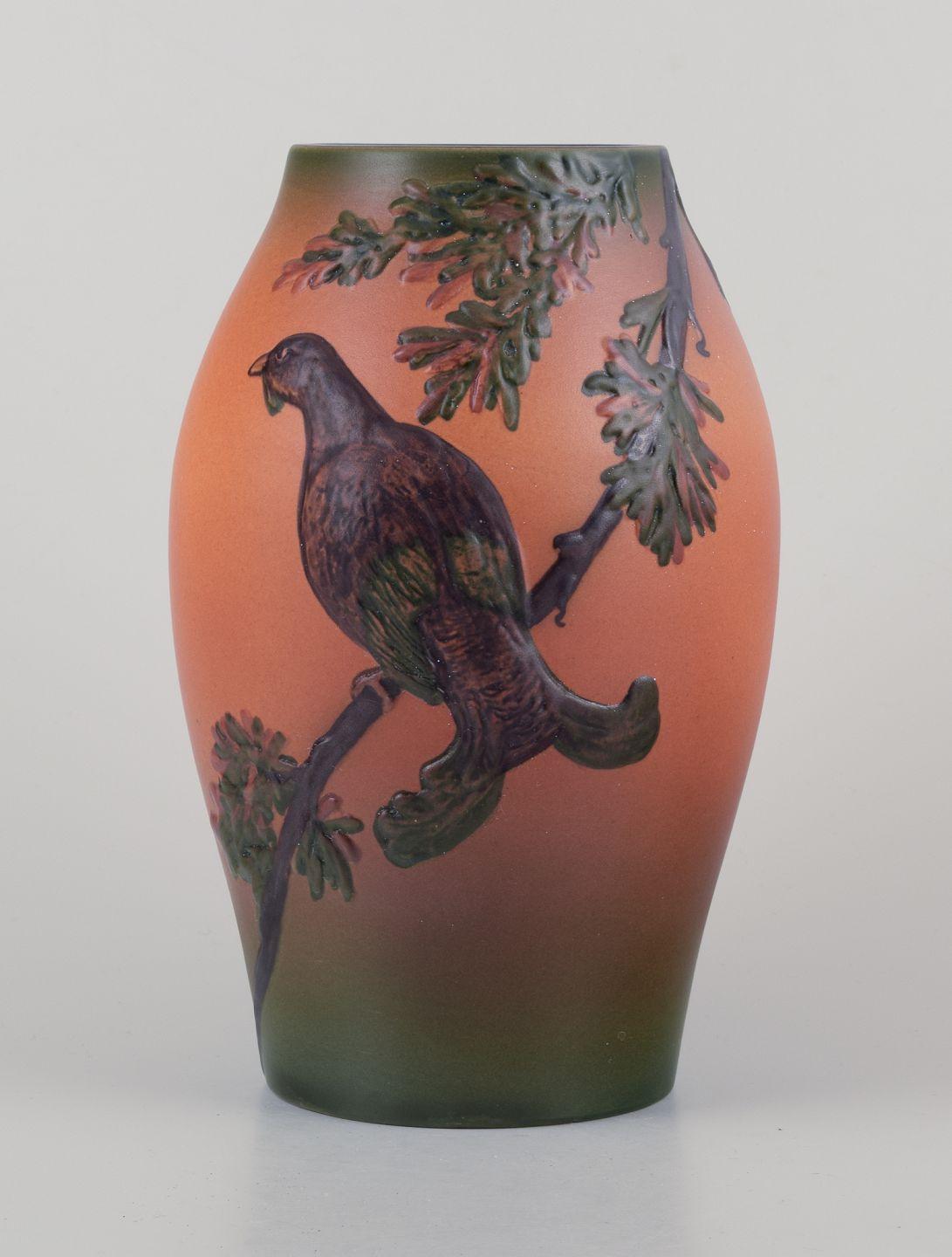 PRE-OWNED GOODS ARE EXEMPT FROM IMPORT TARIFFS FOR U.S., UK, AUSTRALIAN & CANADIAN CUSTOMERS.   
THEREFORE, NO IMPORT TARIFFS WILL BE APPLICABLE TO YOUR PURCHASE. 

Ipsens, Denmark.
Ceramic vase. Motif of bird on branch.
Orange, green and brown