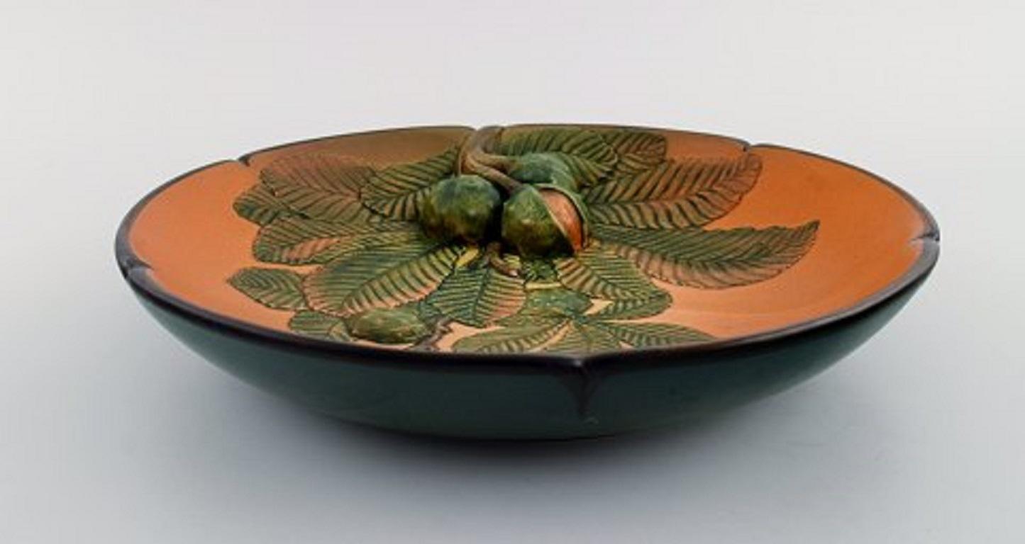 Ipsen's, Denmark. Circular dish with chestnuts in hand painted glazed ceramics. Model number 131, circa 1920
Measures: 28 x 5 cm.
In excellent condition.
Stamped.