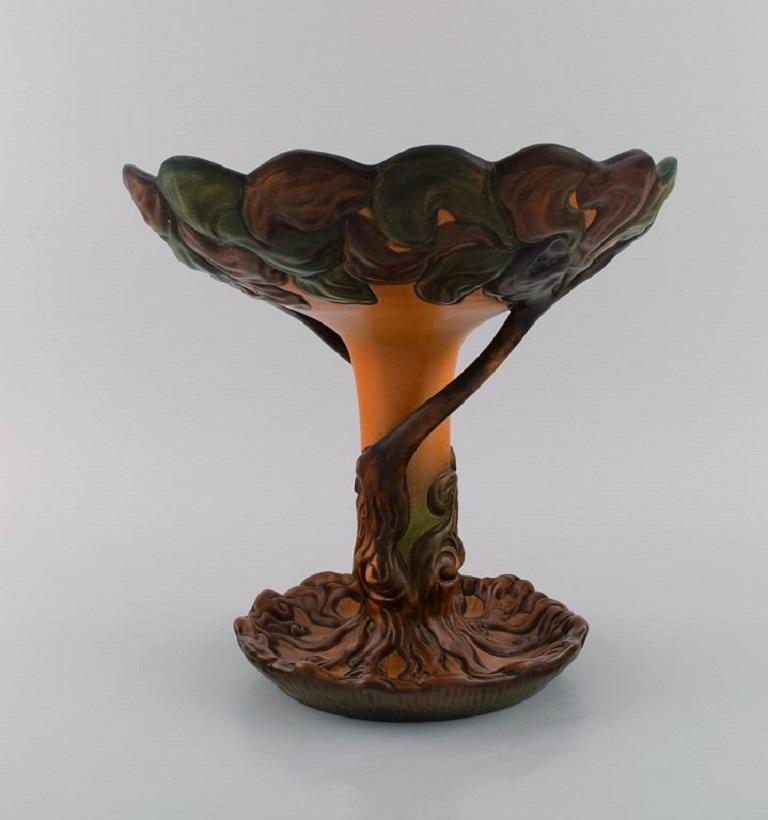 Ipsen's, Denmark. Large and rare Art Nouveau compote in glazed ceramics shaped like a tree. 
1920s. Model number 181.
Measures: 25 x 24.5 cm.
In excellent condition.
Stamped.
