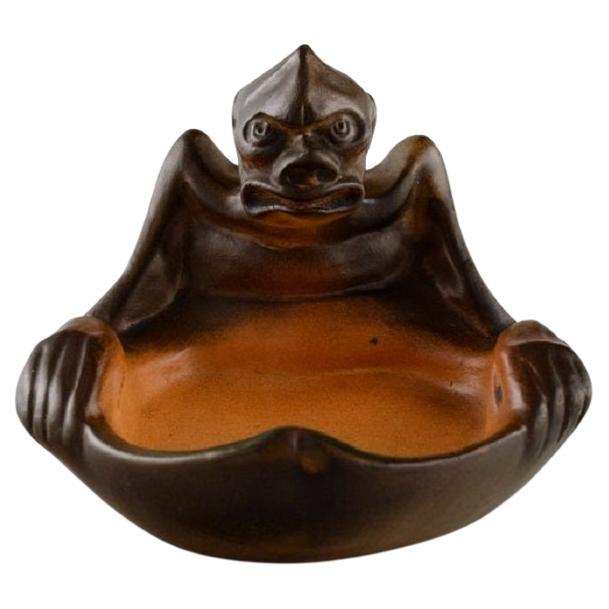 Ipsen
s, Denmark. Rare bowl in hand-painted ceramics modelled with grotesque.