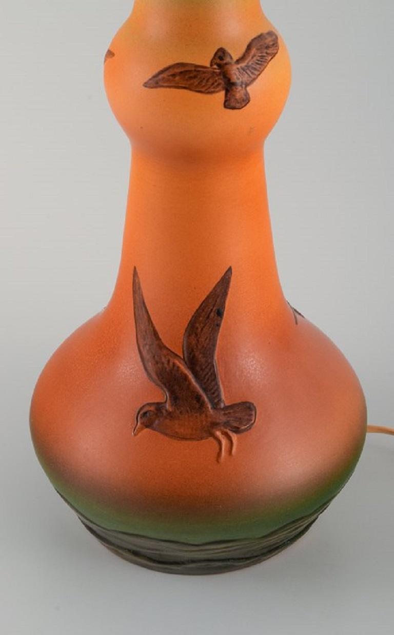 Swedish Ipsens, Denmark. Table lamp in glazed ceramic with hand-painted seagulls. 1940s For Sale