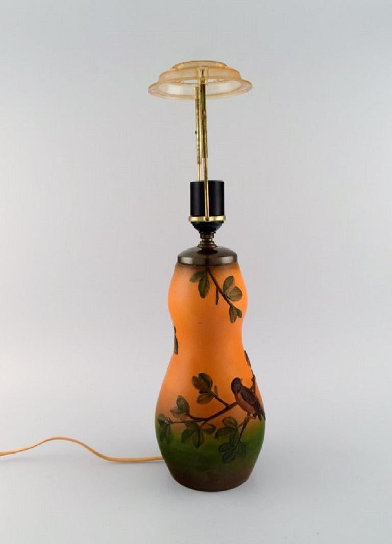 Ipsen's, Denmark. Table lamp in glazed ceramics with hand-painted birds, branches and foliage. 1940s. 
Model number 71.
Measures: 27 x 14 cm (ex socket).
In excellent condition.
Stamped.
