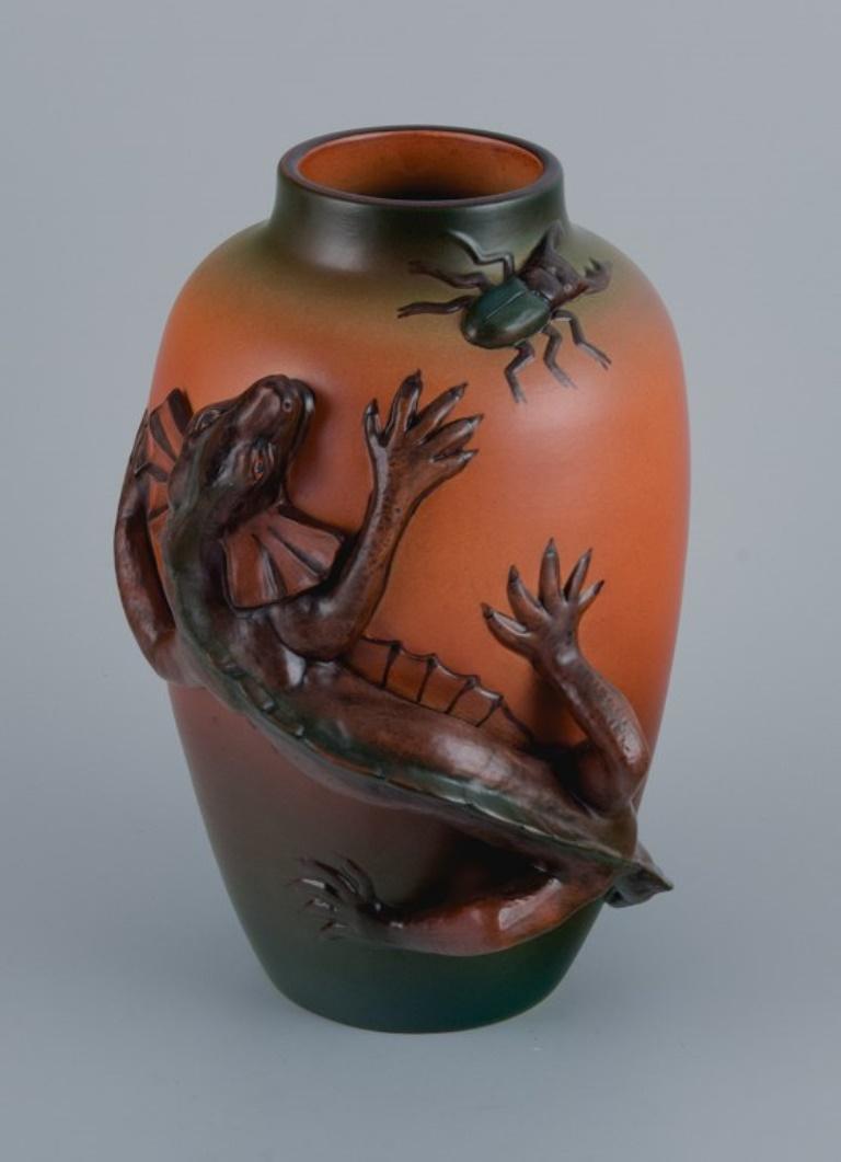 Ipsens, Denmark. 
Vase in hand-painted glazed ceramic with lizard and beetle.
Approx. 1920.
Model number 364.
Marked.
In excellent condition.
Dimensions: H 27.0 x D 18.0 cm.






