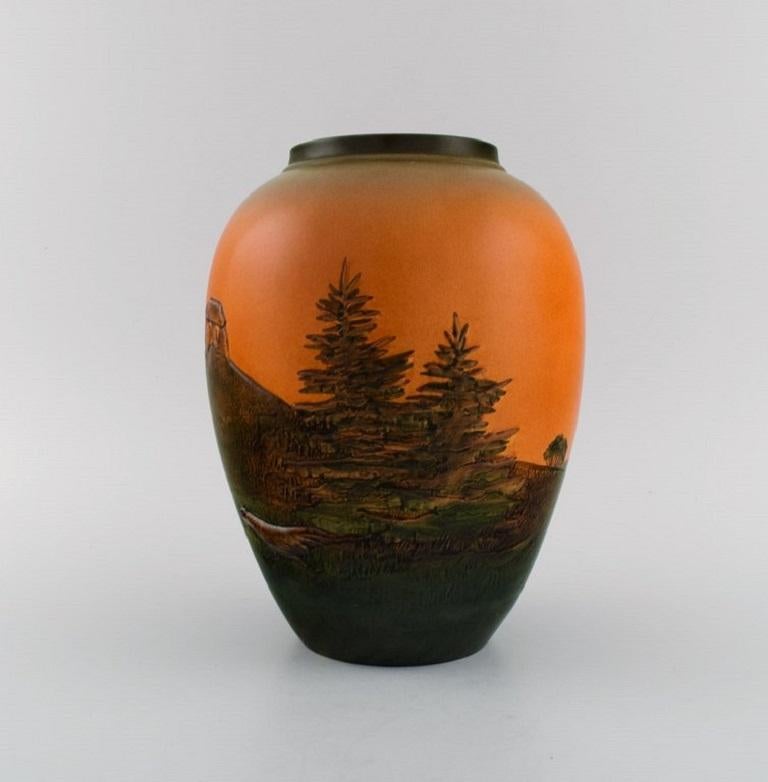 Ipsen's, Denmark. vase in glazed ceramics. 
Hand-painted landscape with burial mound. 
1920s / 30s. Model number 426.
Measures: 22.5 x 17 cm.
In excellent condition.
Stamped.