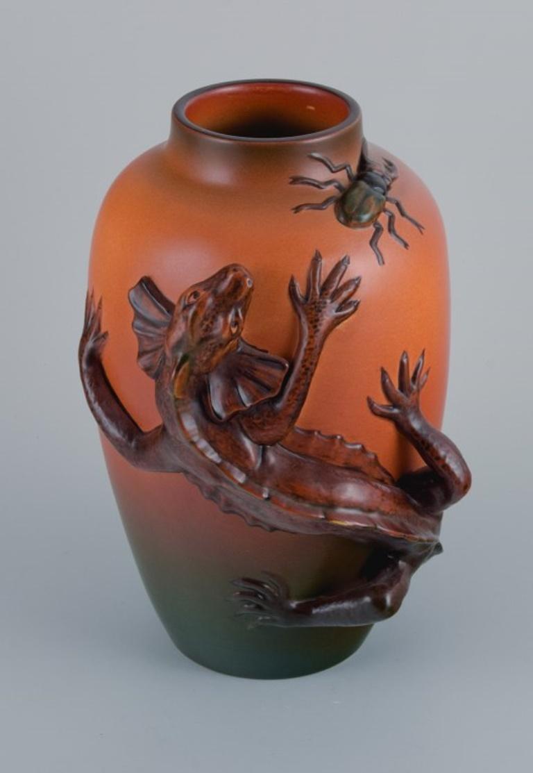 Ipsens, Denmark. Vase in hand-painted glazed ceramic with lizard and beetle.
Approx. 1920.
Model number 364.
Marked.
In excellent condition.
Dimensions: H 27.0 x D 18.0 cm.