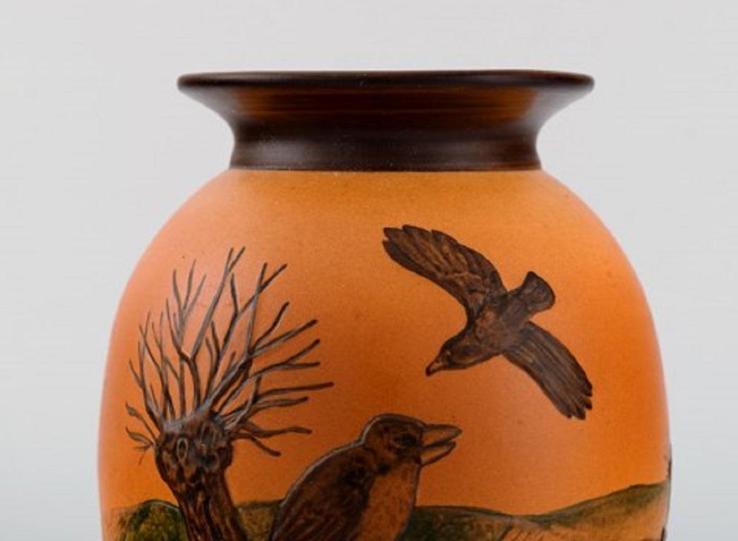 Ipsen's, Denmark. Vase in hand painted glazed ceramics. Landscape with birds. Model number 477, circa 1920
Measures: 18 x 14 cm.
In excellent condition.
Stamped.