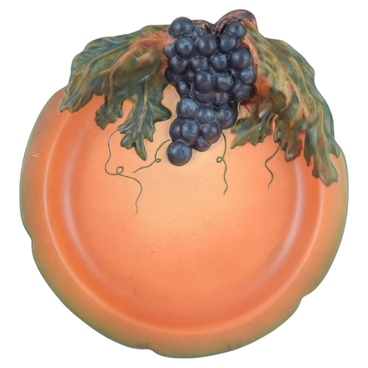 Ipsens Enke, Denmark. Ceramic dish with grape motif, ca. 1920s/30s. For Sale