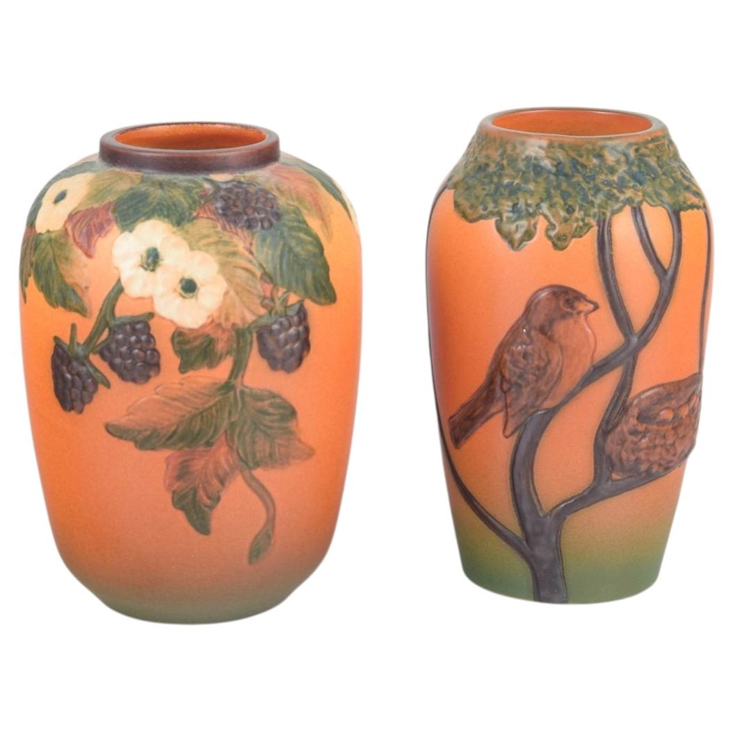 Ipsens Enke, Denmark. Two ceramic vases in warm orange and green tones, 1920/30s
