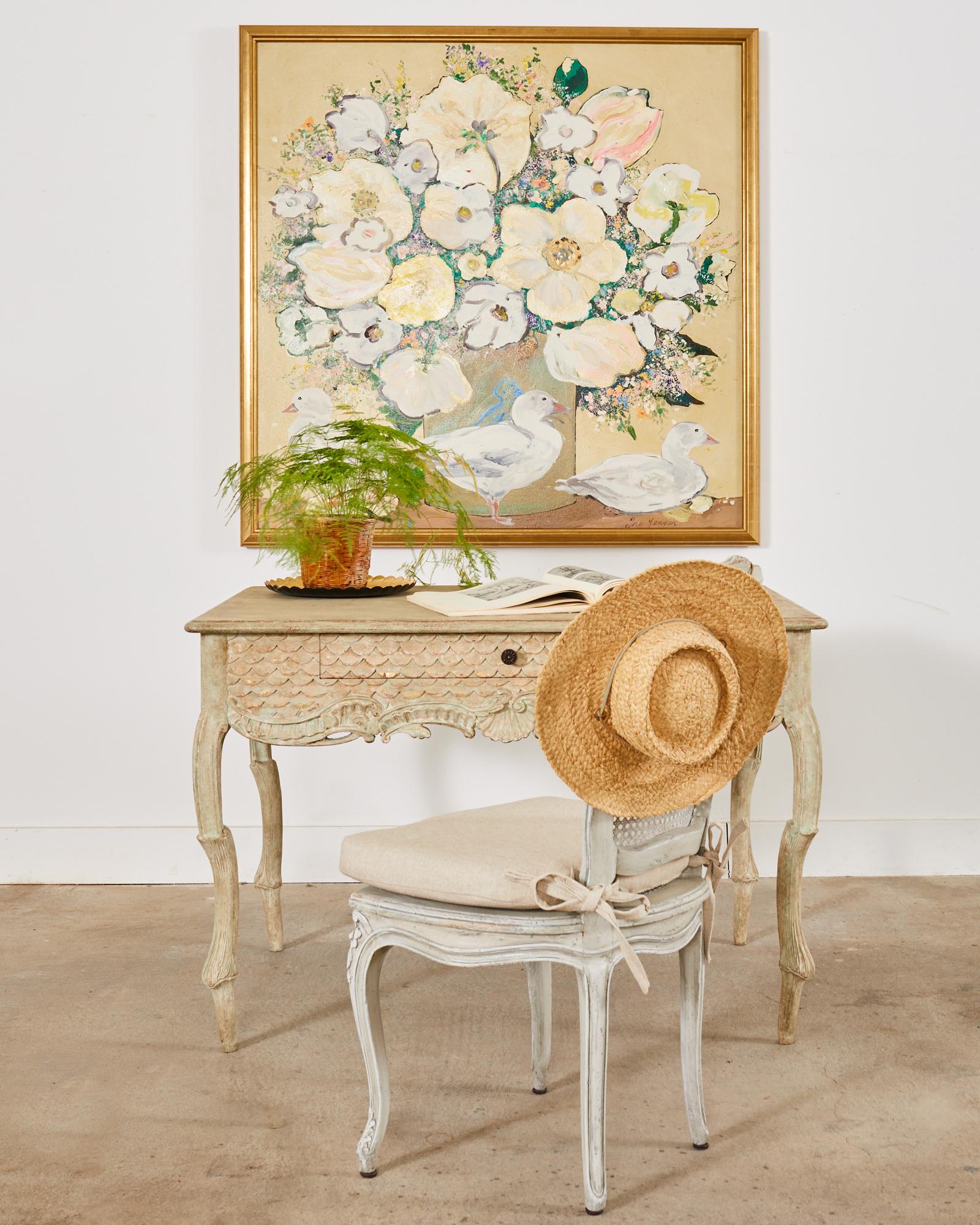 Large floral still life painting by artist Ira Yeager (American 1938-2022). The canvas painting features a grey vase with a magnificent floral bouquet and three white ducks in Yeager's whimsical style. The canvas is set in a 22k gold leaf