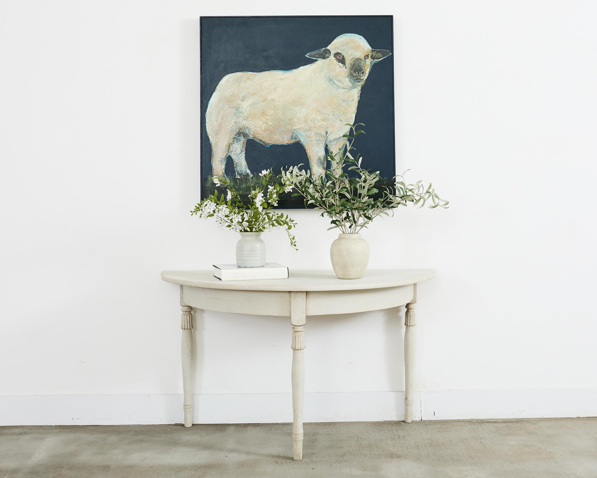 Charming signed oil on canvas painting of a wooly white lamb over a dramatic indigo blue background by artist Ira Yeager (American 1938-2022). The lamb is standing on green grass with an artist signature on the lower left side of the canvas. The