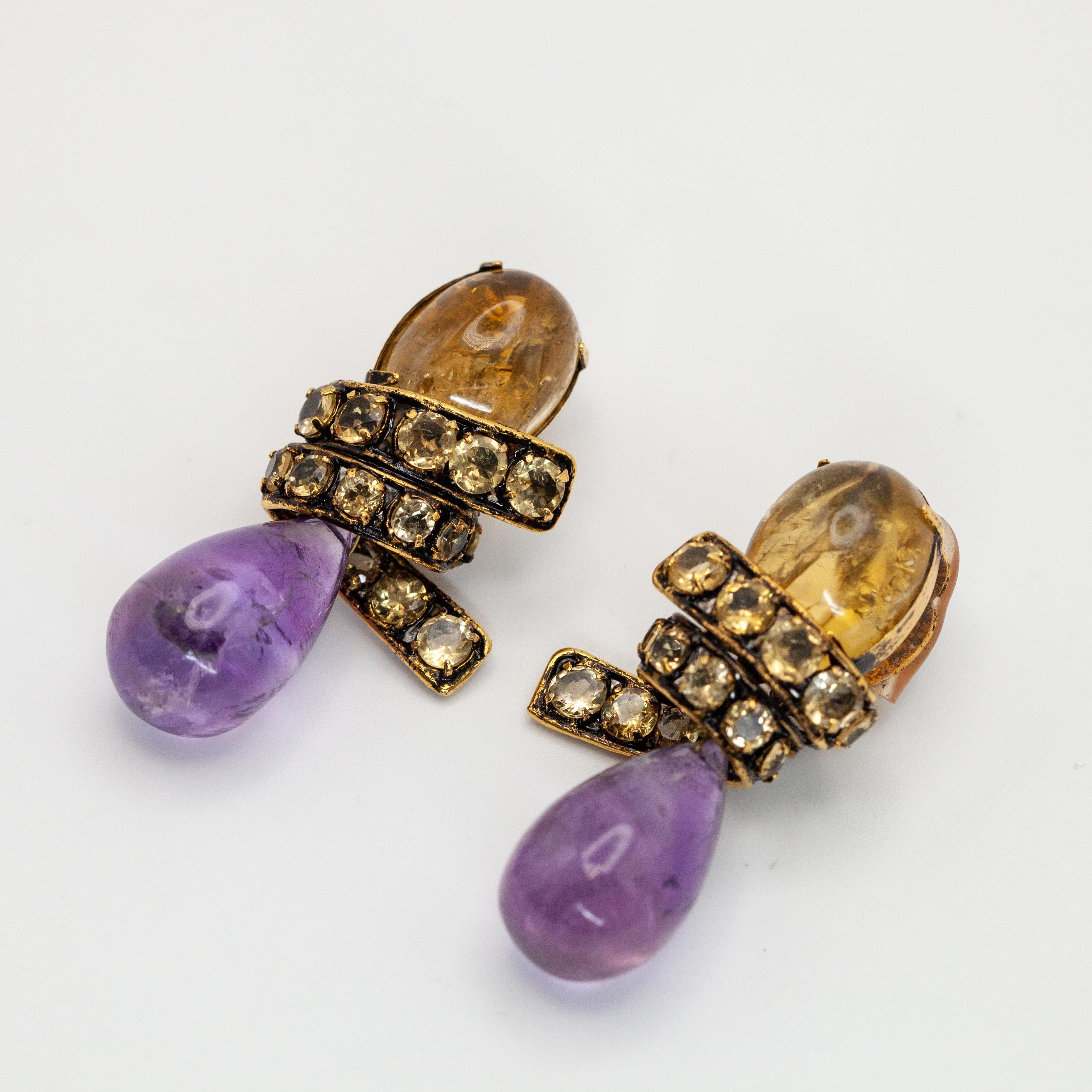 Large Iradj Moini citrine and amethyst ribbon drop earrings with 1 cabochon citrine and 1 teardrop amethyst

Approximate Weight: 41.1 grams

Approximate Measurements: 
Overall - 55mm x 26mm
Amethyst drop - 23.3mm x 15.4mm

Hallmark: Iradj Moini

