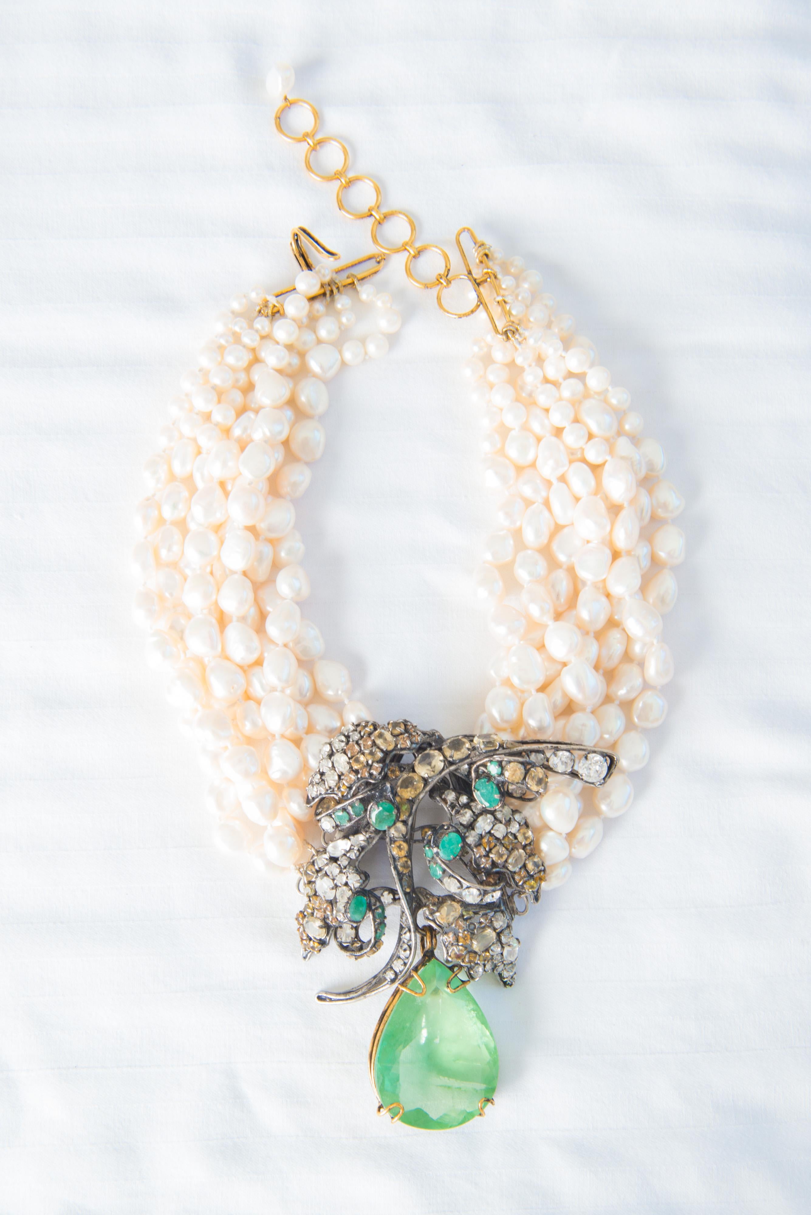 Beautiful Iradj Moini seven strand pearl necklace with removable pale emerald colored pear shape stone brooch decorated with clear and colored small stones.