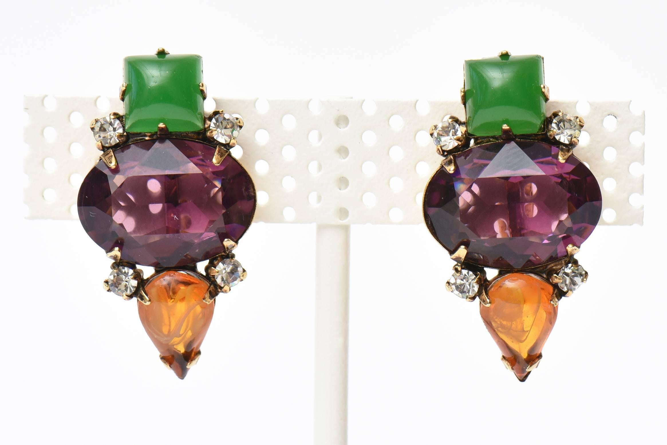 These lovely vintage Iradj Moini rhinestone and glass clip on earrings are a beautiful combination of gorgeous jewel tone colors. They can go dressy for evening and have an elegant look to them on the ear lobe. They are from the 80's. They were made